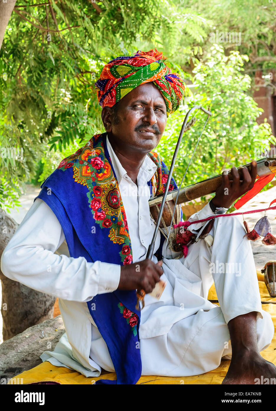 Folk musician playing traditional string instrument at Jaswant thada