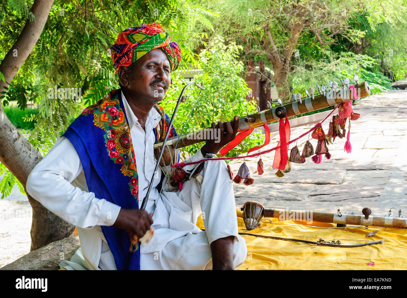 Folk musician playing traditional string instrument at Jaswant thada