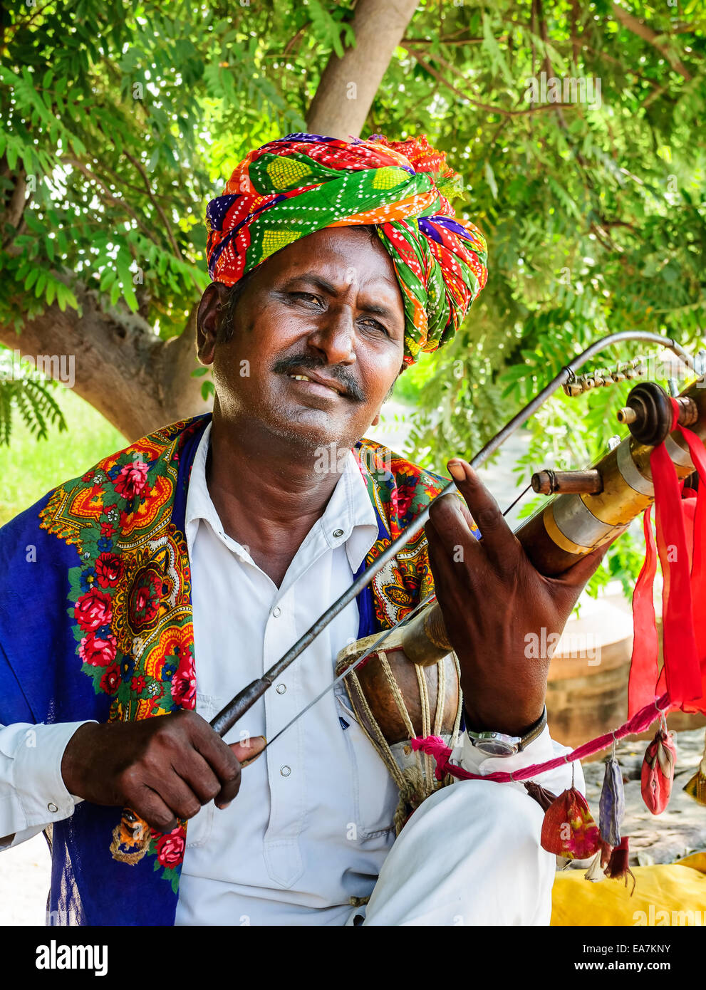 Folk musician playing traditional string instrument at Jaswant thada, Jodhpur, Rajasthan, India