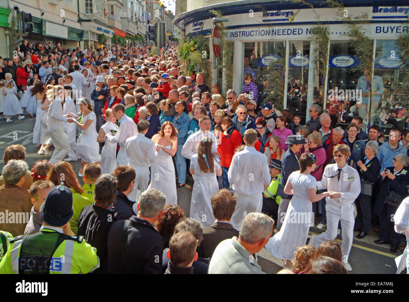 The Childrens Dance down Maneage Street to the Guildhall on Flora Day in Helston Kerrier West Cornwall South West England UK Stock Photo