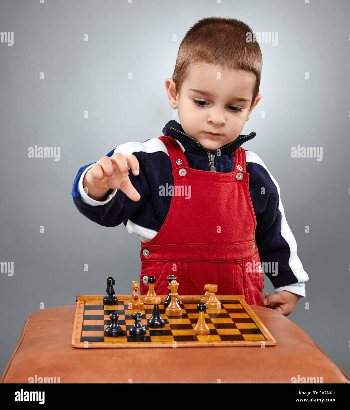 Adorable little boy learning how to play chess stock photo alamy