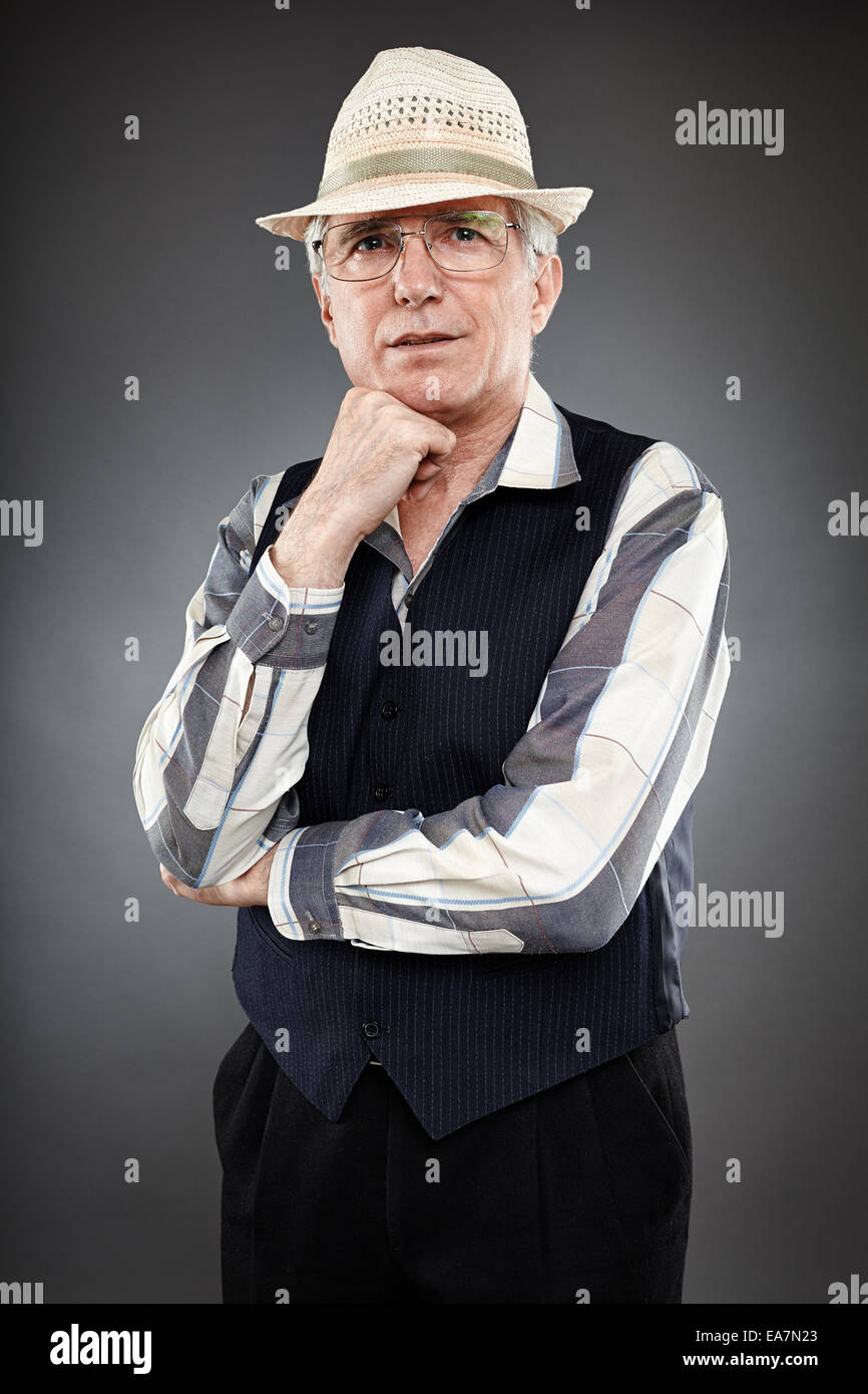 Caucasian senior man of 60 years old standing against gray background