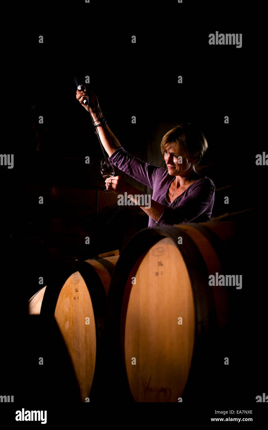 Albourne Estate Vineyard in West Sussex, UK. Alison Nightingale checking the wine during the process. Stock Photo