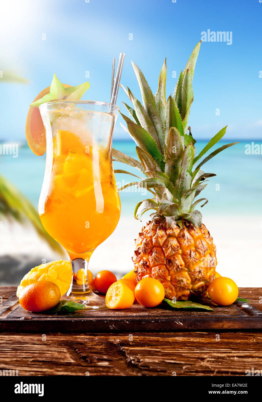 Fresh summer orange drink, blur beach on background Stock Photo