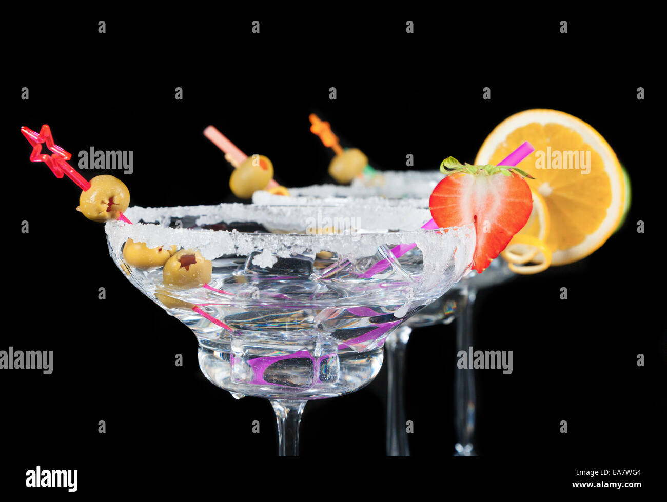 Glasses of alcohol cocktails isolated on black background Stock Photo