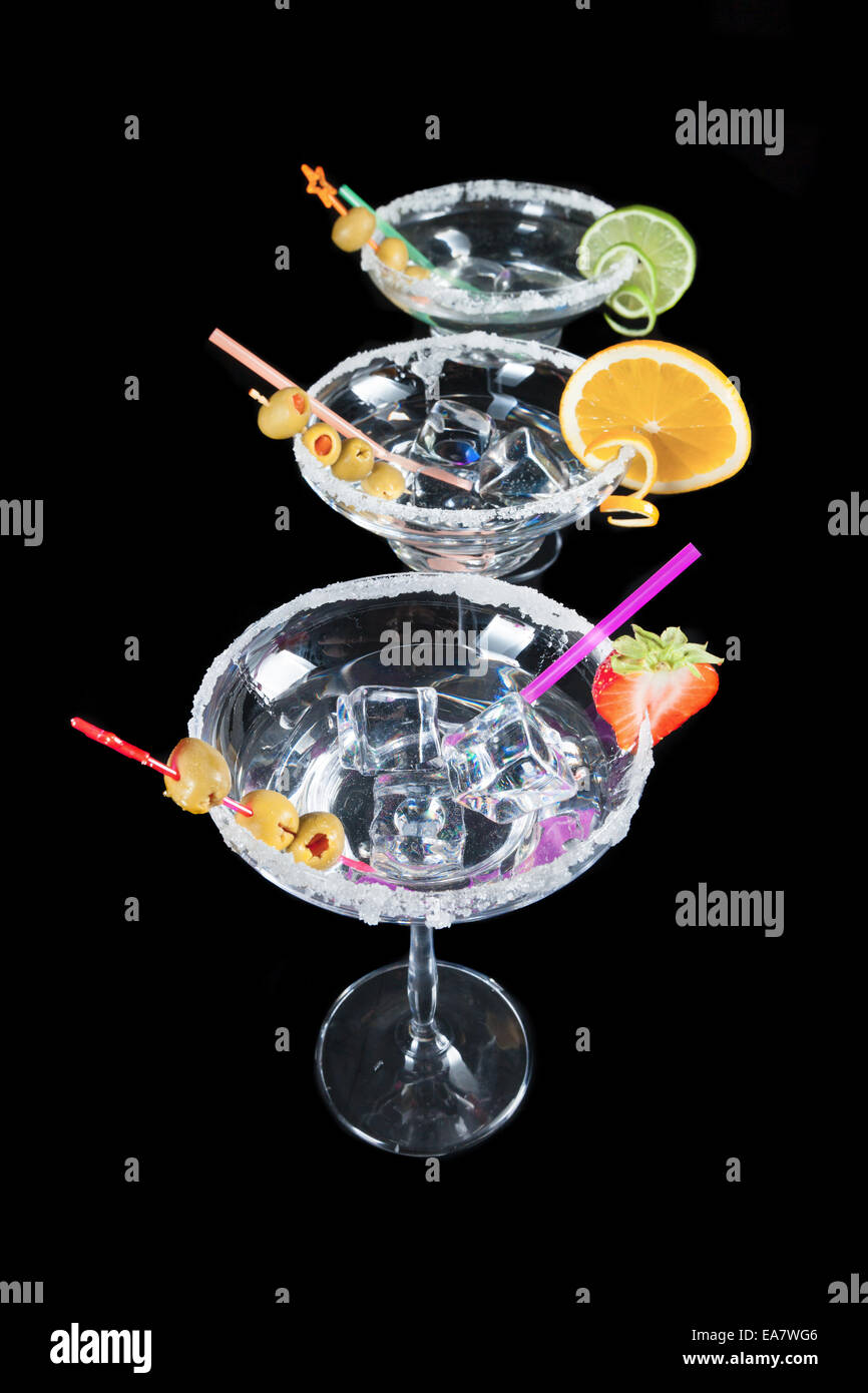 Glasses of alcohol cocktails isolated on black background Stock Photo