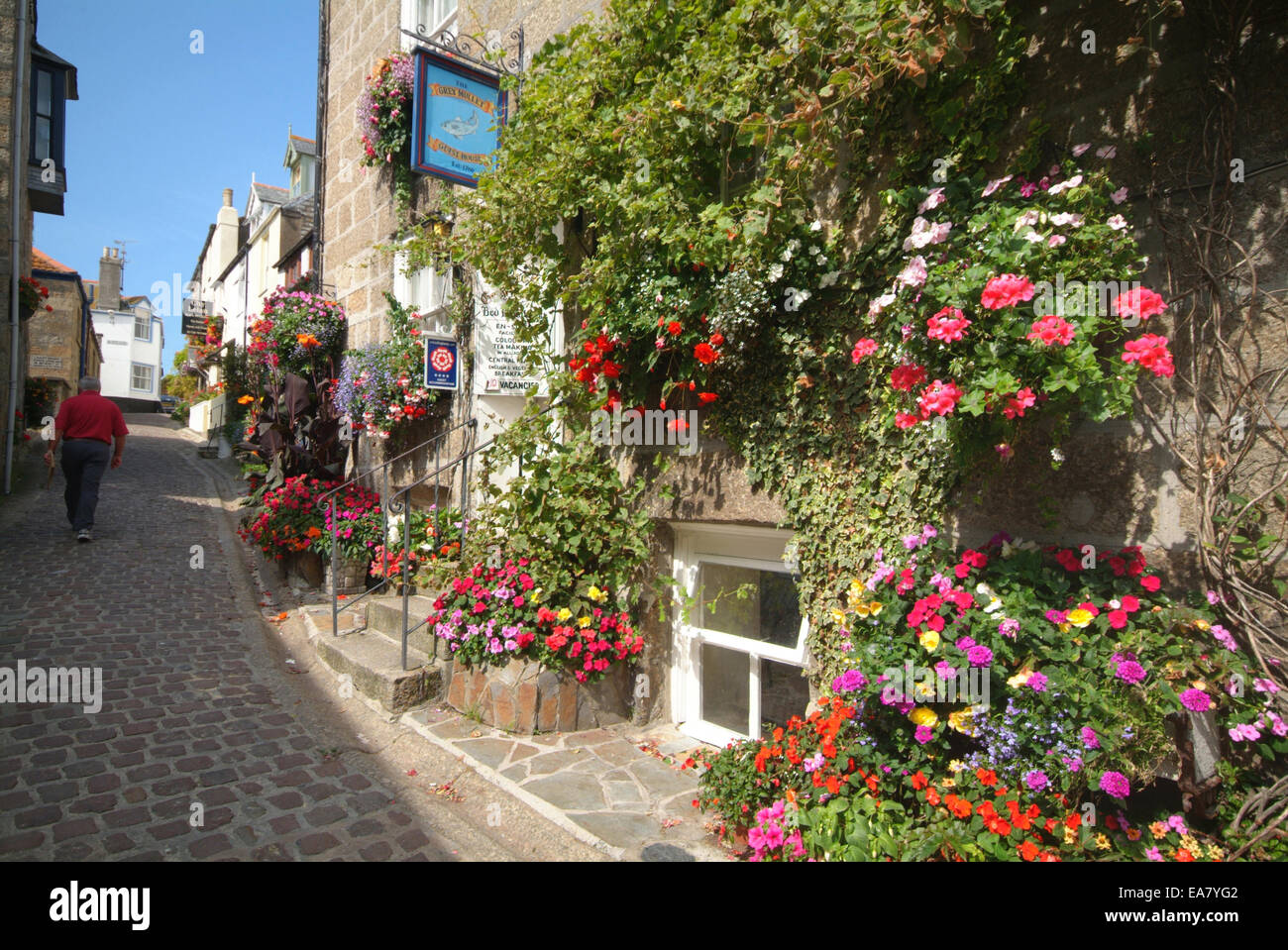 Bunkers Hill cobbled street with flowers in hanging baskets & tubs in
