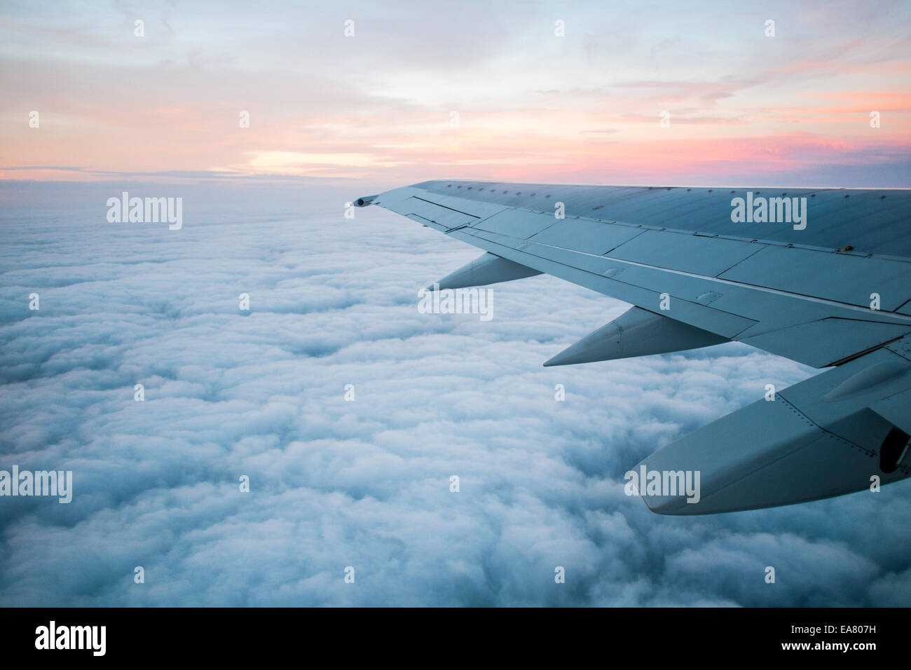View from window seat, Airplane flying above clouds Stock Photo