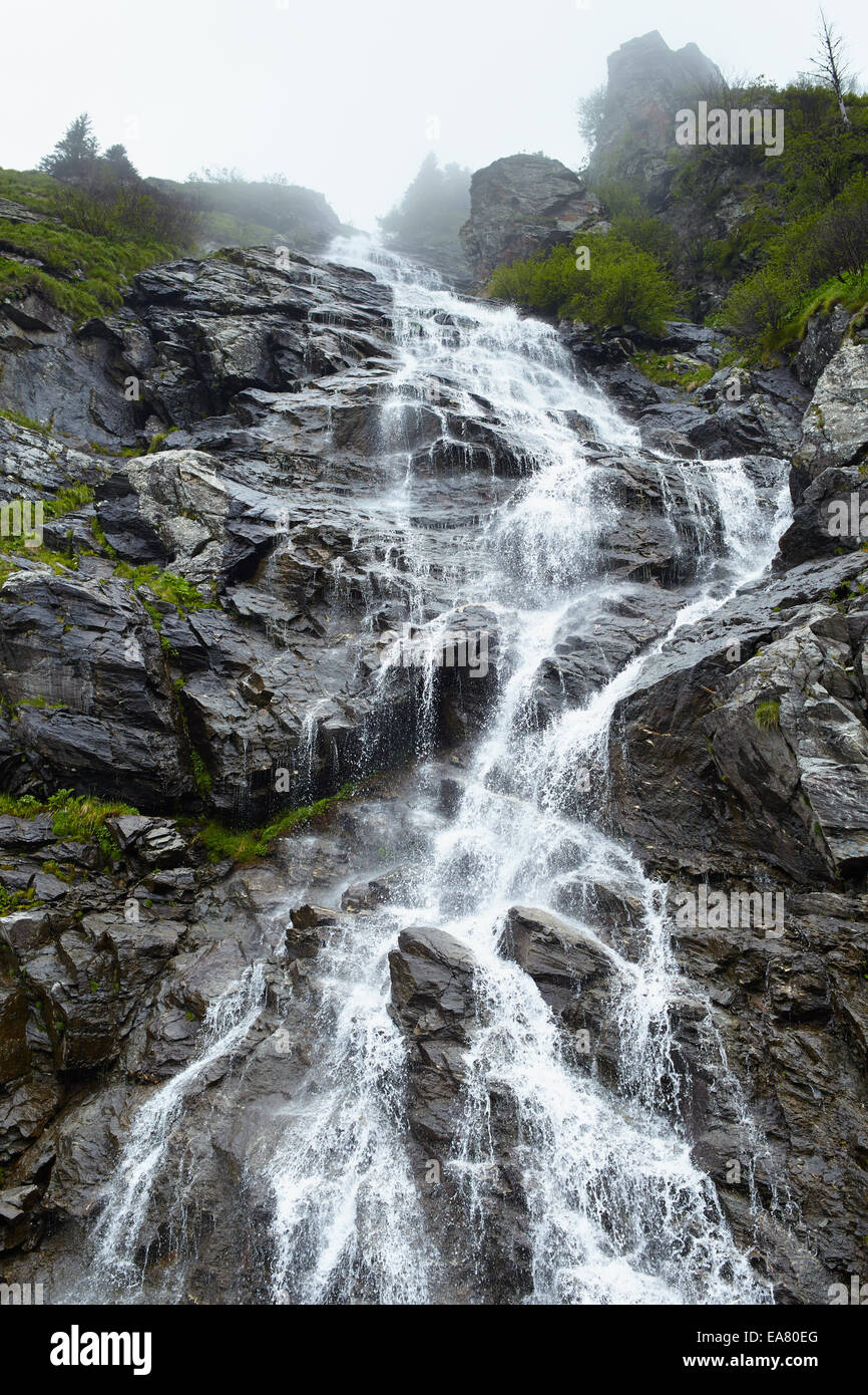 Landscape with a waterfall on a rocky mountain Stock Photo - Alamy