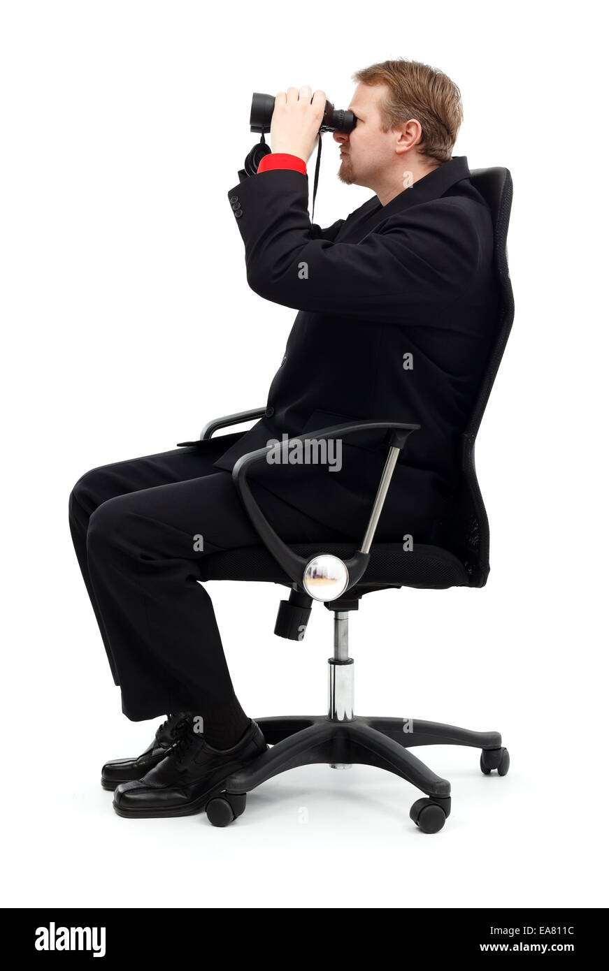 Business man sitting in chair and searching with binoculars Stock Photo