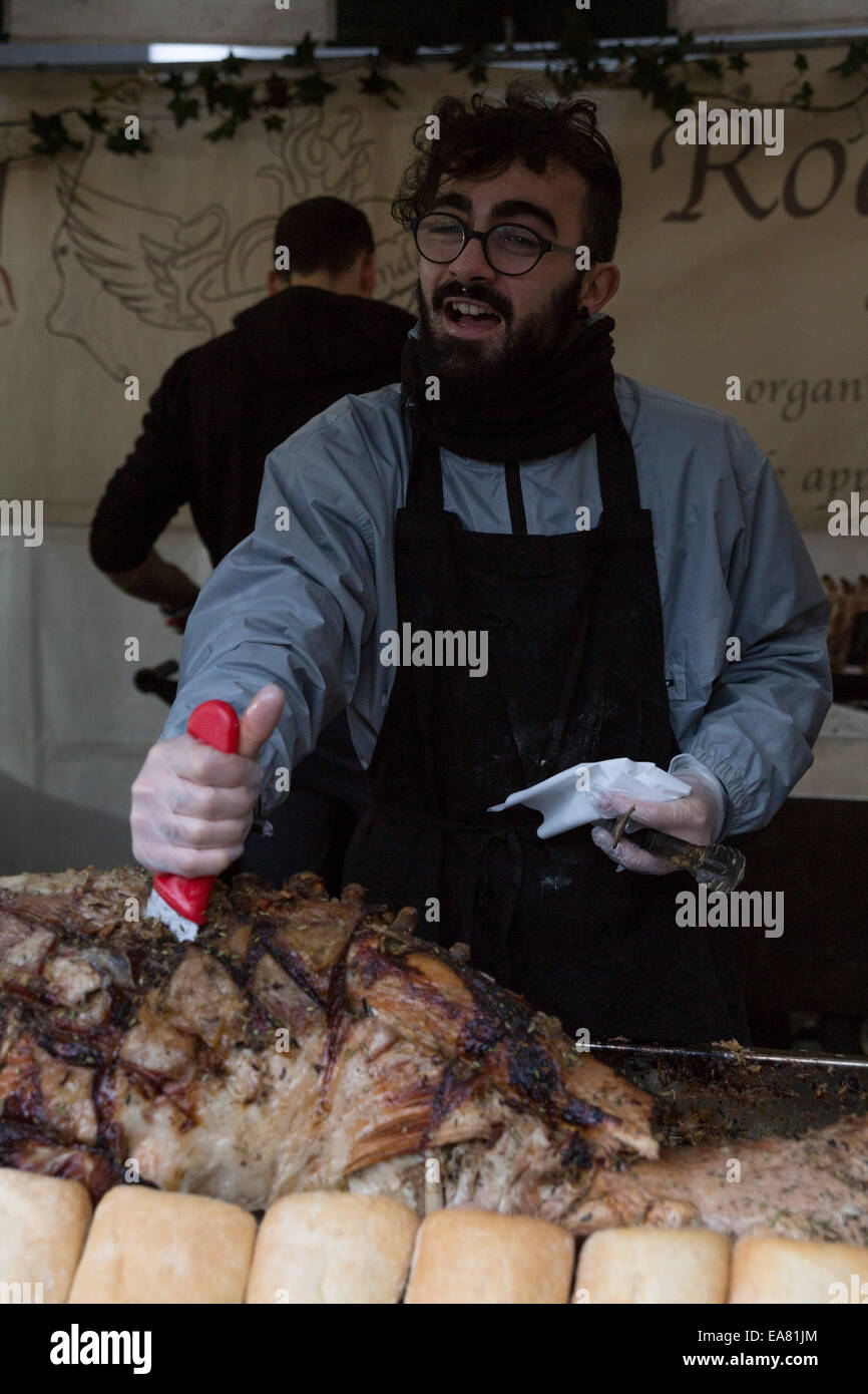 Italian food vendor cutting a slice of porchetta. The Real Food Market, held weekly, Friday-Sunday, on Southbank Centre Square, hosts over 40 small producers and independent traders of  fresh, high quality, great value food and drink. Stock Photo