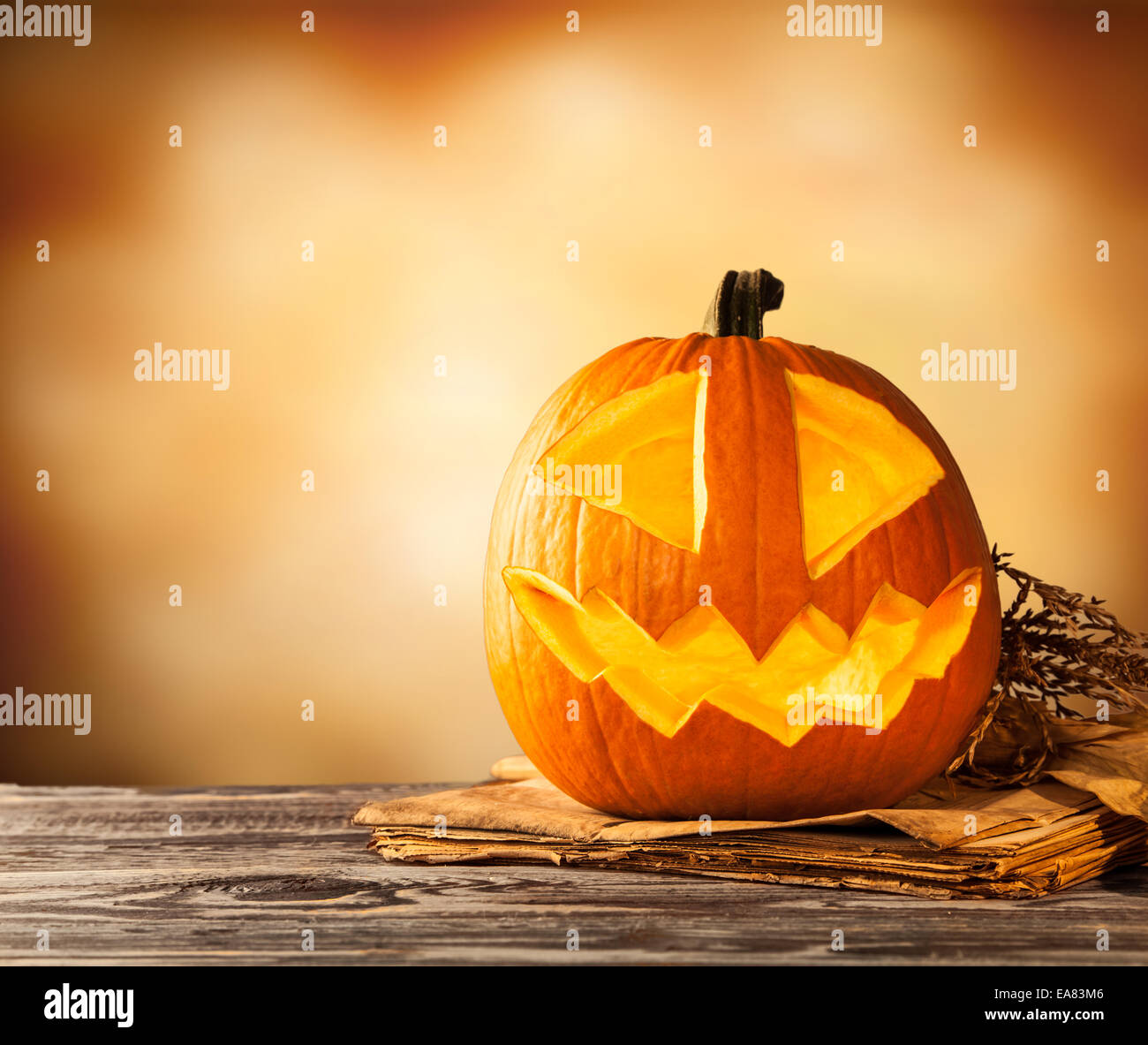 Evil halloween pumpkin on wood with free space for text Stock Photo