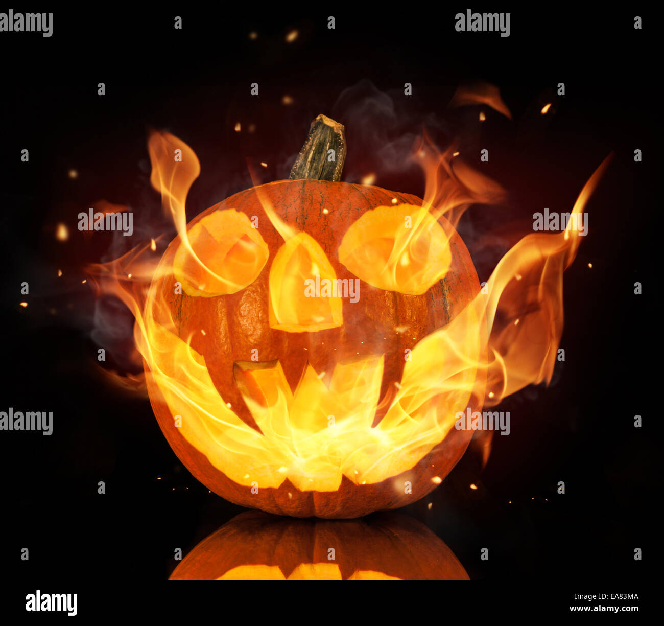 Halloween pumpkin with fire flames isolated on black background Stock Photo