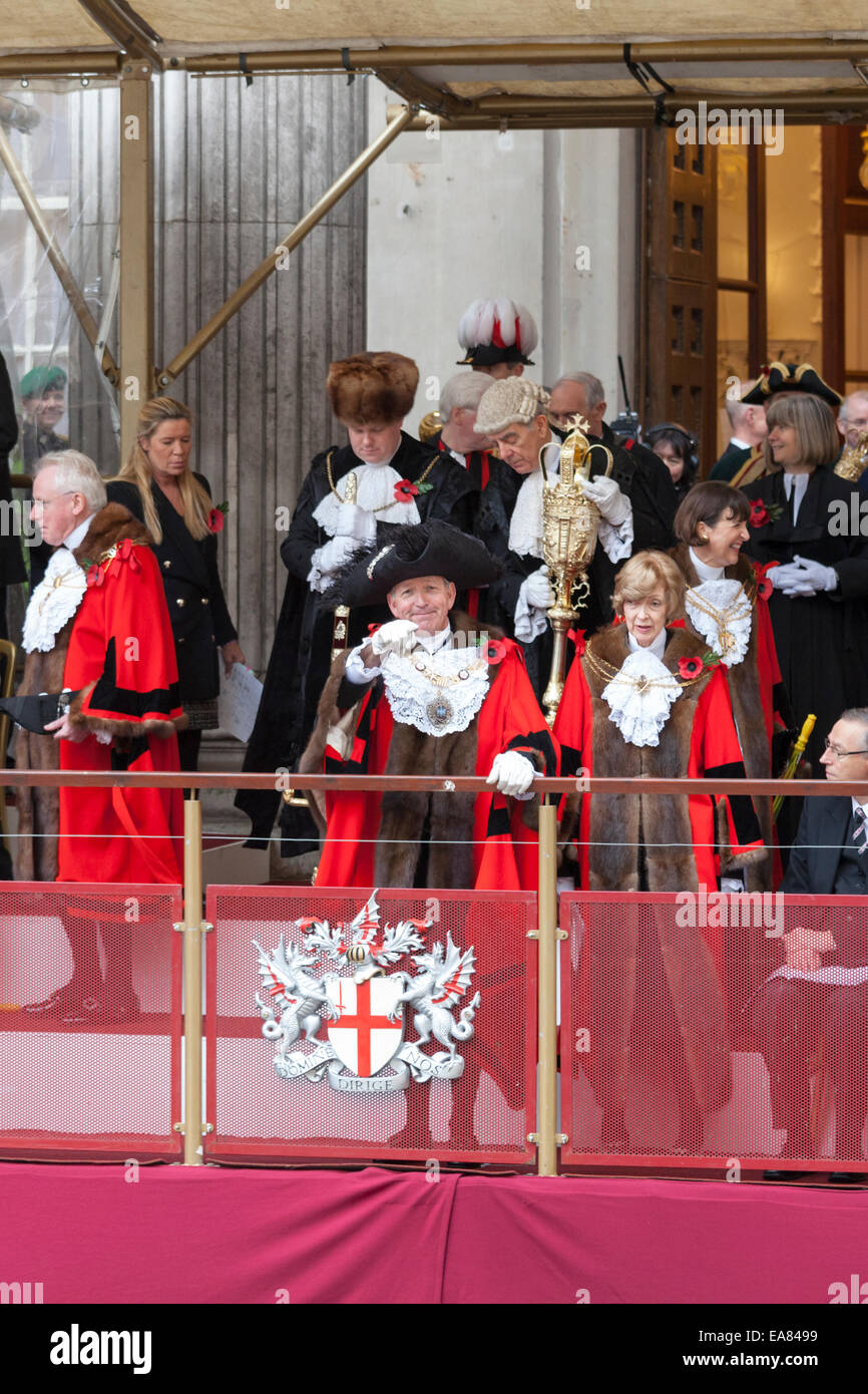 8th November 2014, Lord Mayor's Show, City of London, London, UK. The new 687th Lord Mayor, Alan Yarrow (front left), waves to members of the public from Mansion House balcony at the start of the procession. The outgoing mayor, Fiona Woolf, CBE stands to his right. The Lord Mayor's Show is the oldest civil procession in the world, it celebrates the start of a one-year term for the new Mayor of the City of London. Stock Photo