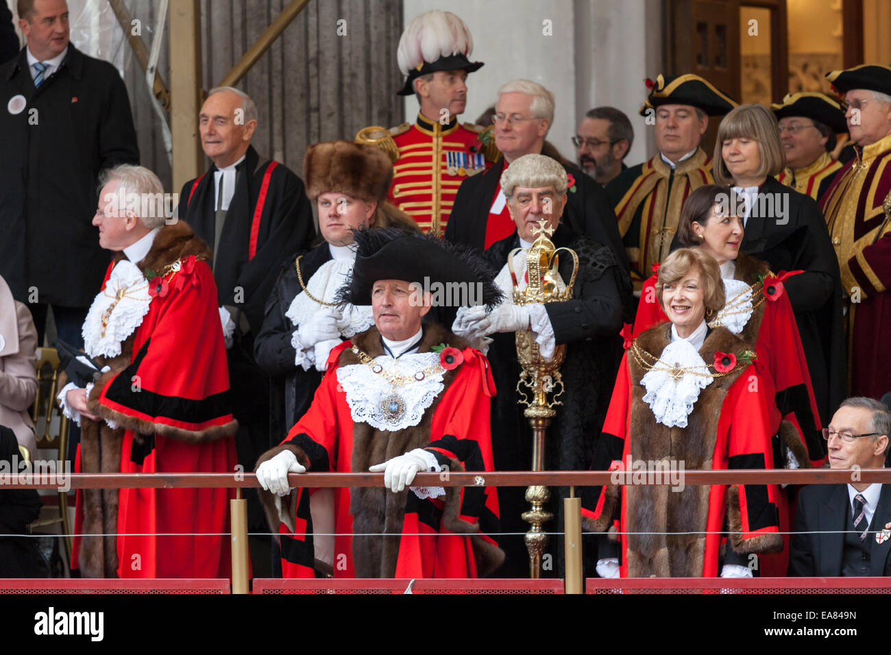 8th November 2014, Lord Mayor's Show, City of London, London, UK. The new 687th Lord Mayor, Alan Yarrow (front middle), watches the procession from Mansion House balcony. The outgoing mayor, Fiona Woolf, CBE stands to his right. The Lord Mayor's Show is the oldest civil procession in the world, it celebrates the start of a one-year term for the new Mayor of the City of London. Stock Photo