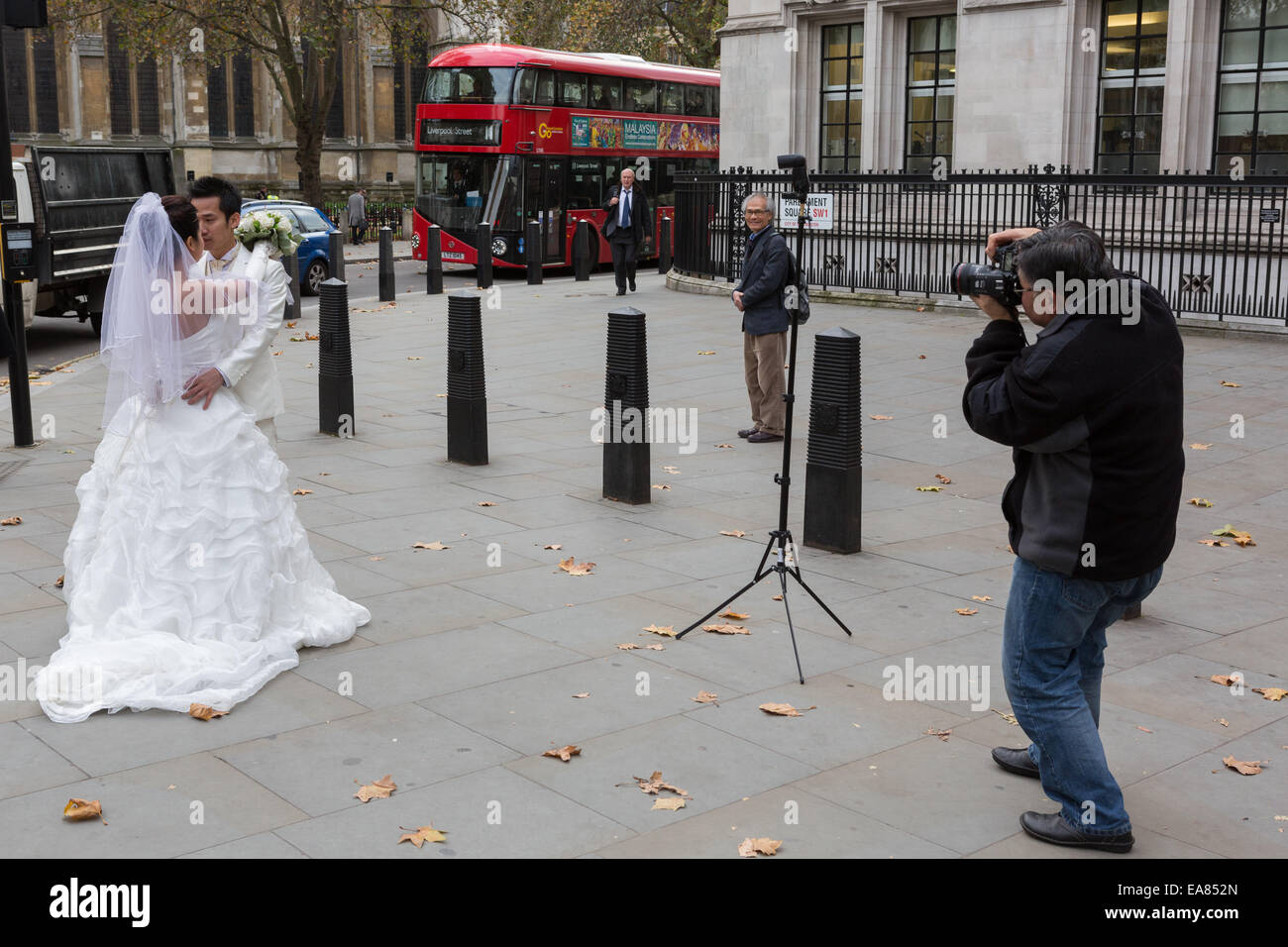 A Chinese couple have wedding photographs taken outside Westminster Abbey in London, England, UK Stock Photo