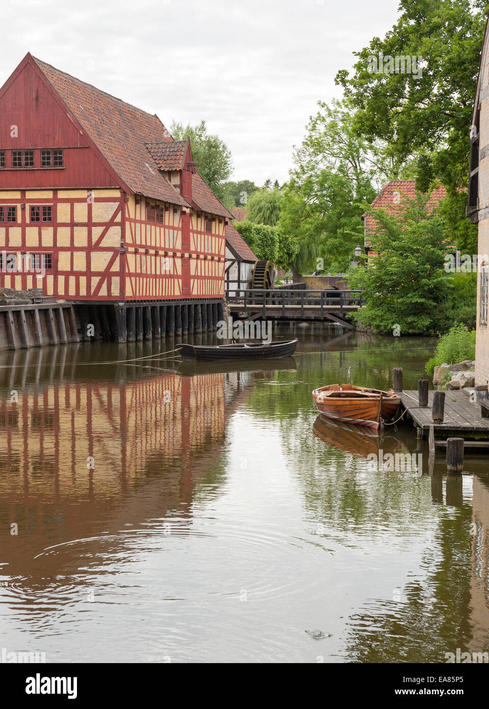 Half Timbered river houses of old Aarhus. Two small row boats float in the water in front of  traditional Danish houses Stock Photo
