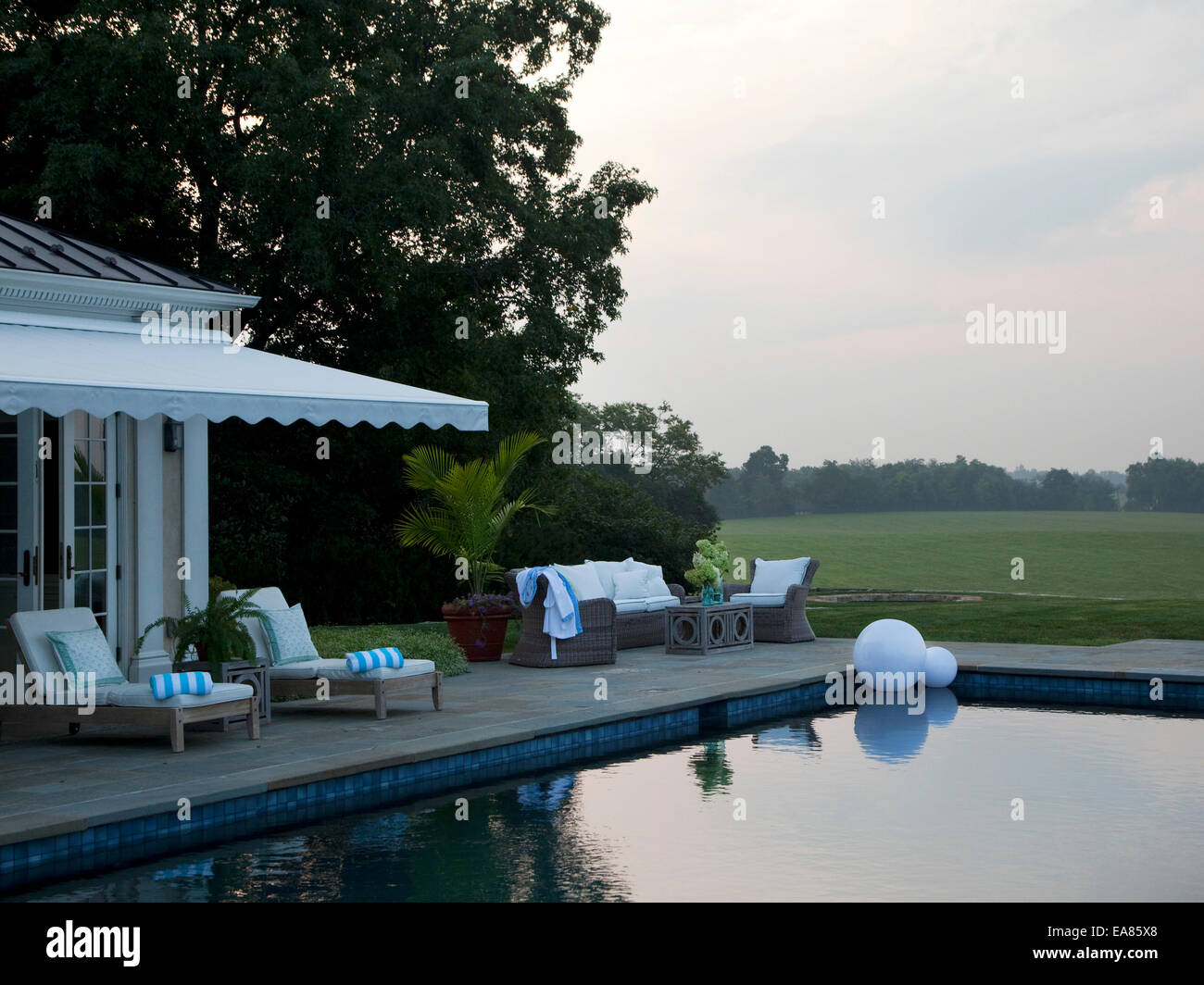 swimming pool on country estate at sunrise Stock Photo