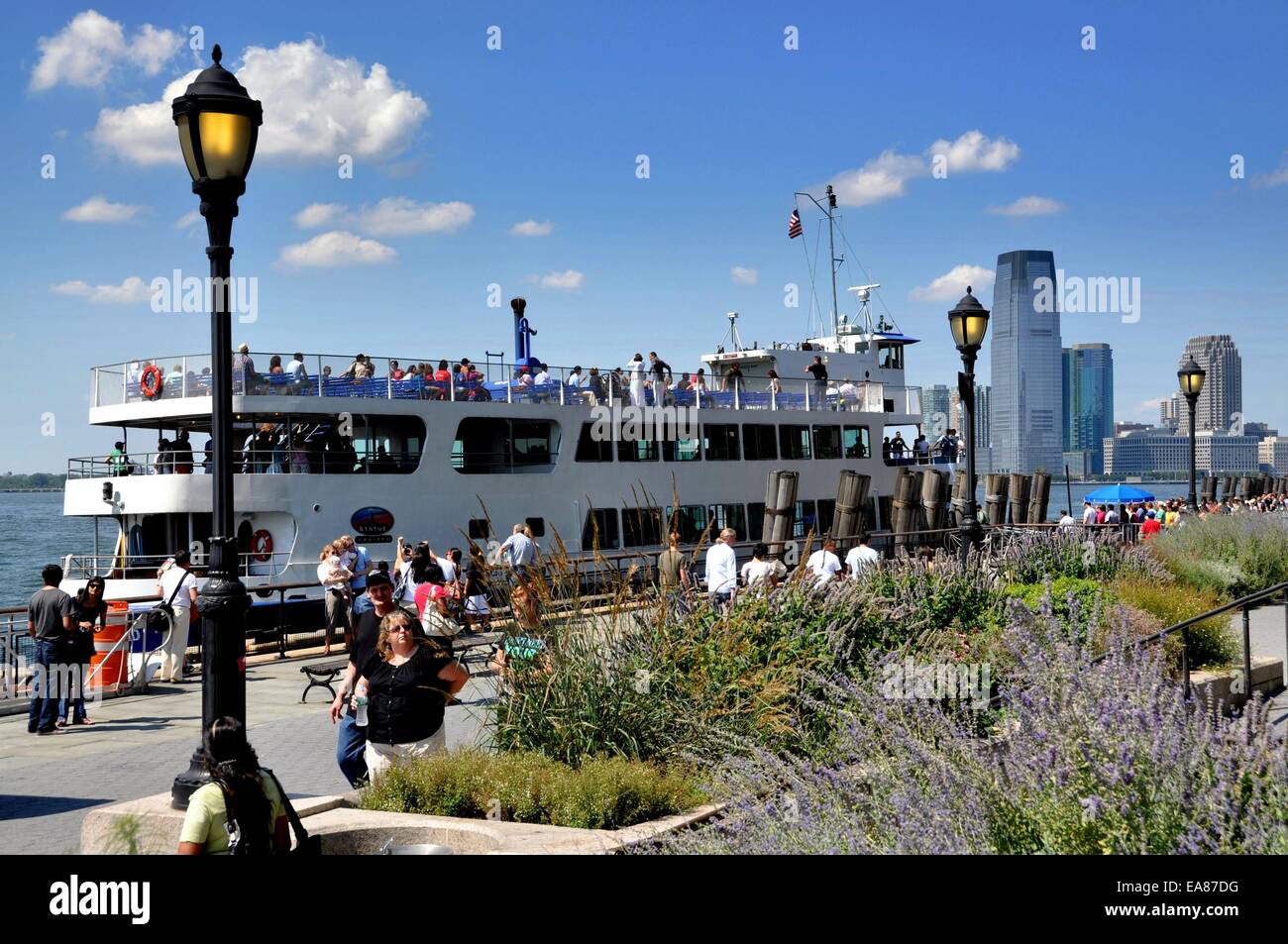 NYC: The Miss Ellis Island ferry passengers in Battery Park for the trip to the Statue of Liberty Stock Photo - Alamy