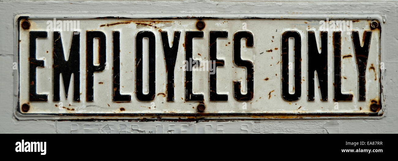 Rusty Old Employees Only Sign Stock Photo