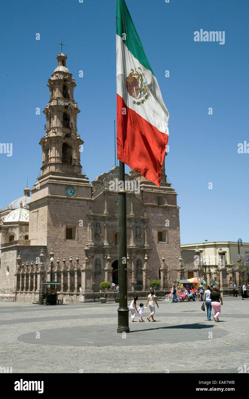 The flag of the Republic of Mexico, Plaza de la Patria (Cathedral in background), Aguascalientes, Mexico Stock Photo