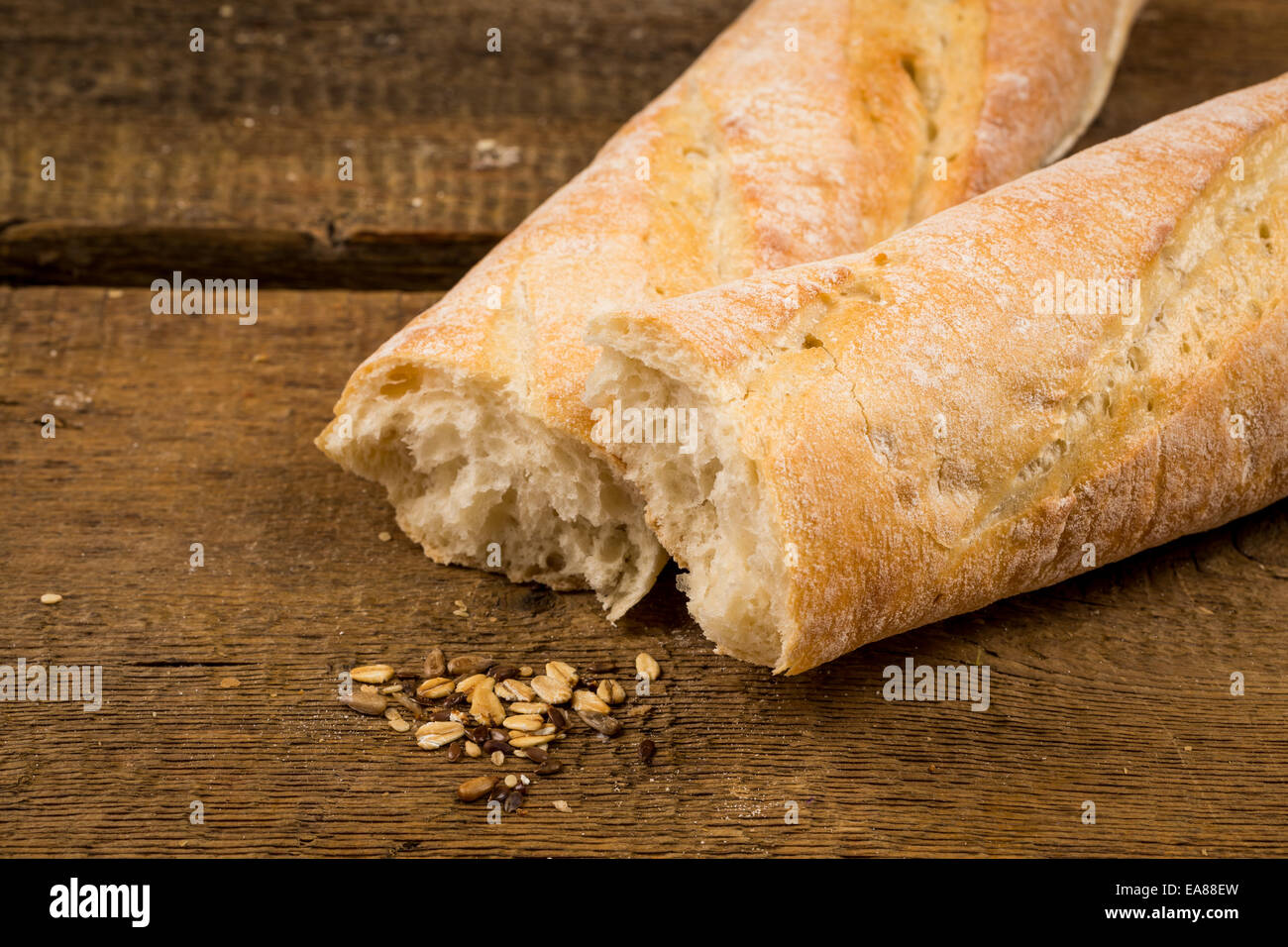 French baguette white bread on a wooden background Stock Photo - Alamy