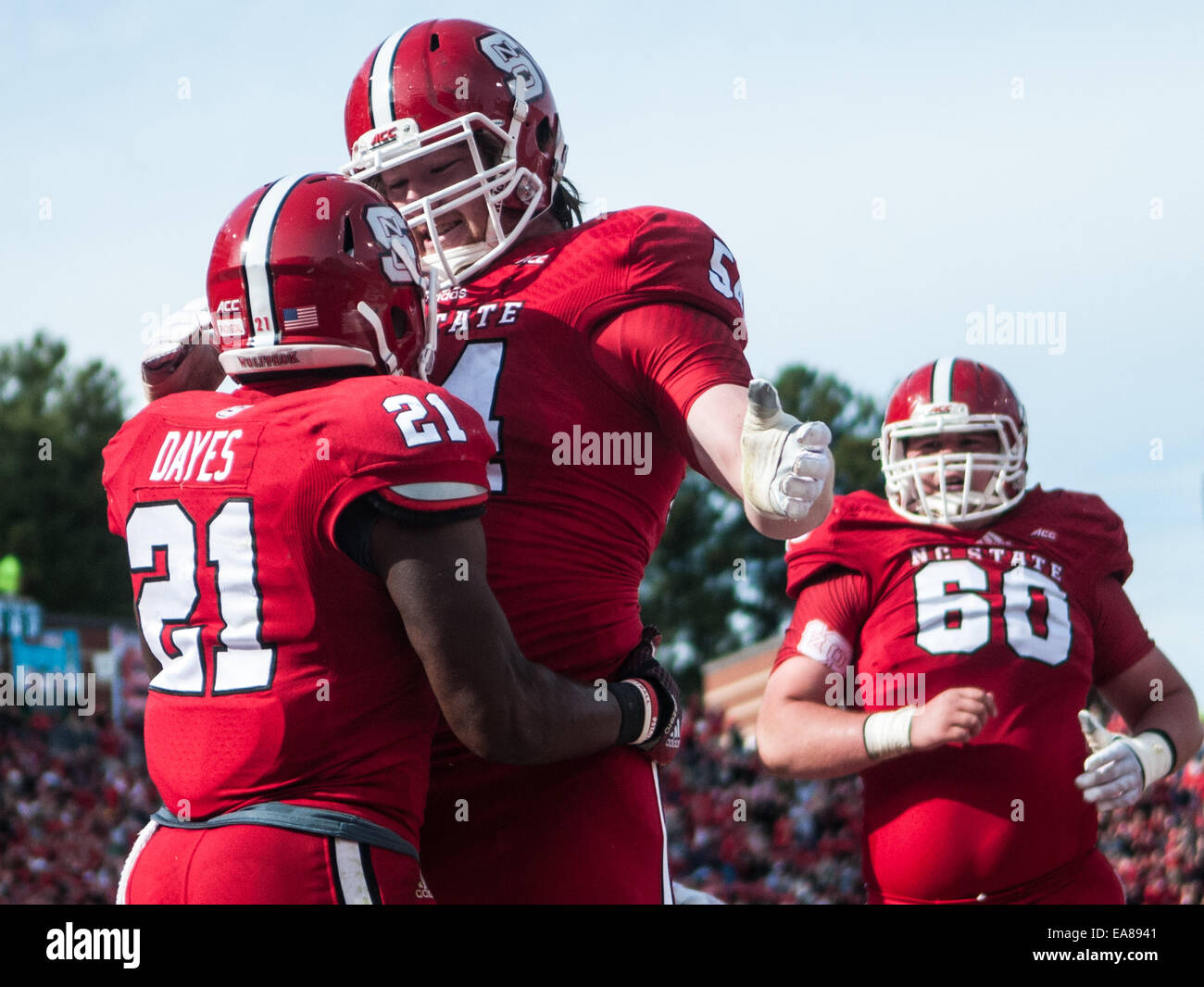 Raleigh, North Carolina, US. 8th Nov, 2014. Nov. 8, 2014 - Raleigh, N.C., USA - North Carolina State Wolfpack running back Matt Dayes (21) is congratulated by Wolfpack guard Joe Thuney (54) during Saturday's game against the Georgia Tech Yellow Jackets. The Yellow Jackets defeated the Wolfpack, 56-23. Credit:  Timothy L. Hale/ZUMA Wire/ZUMAPRESS.com/Alamy Live News Stock Photo