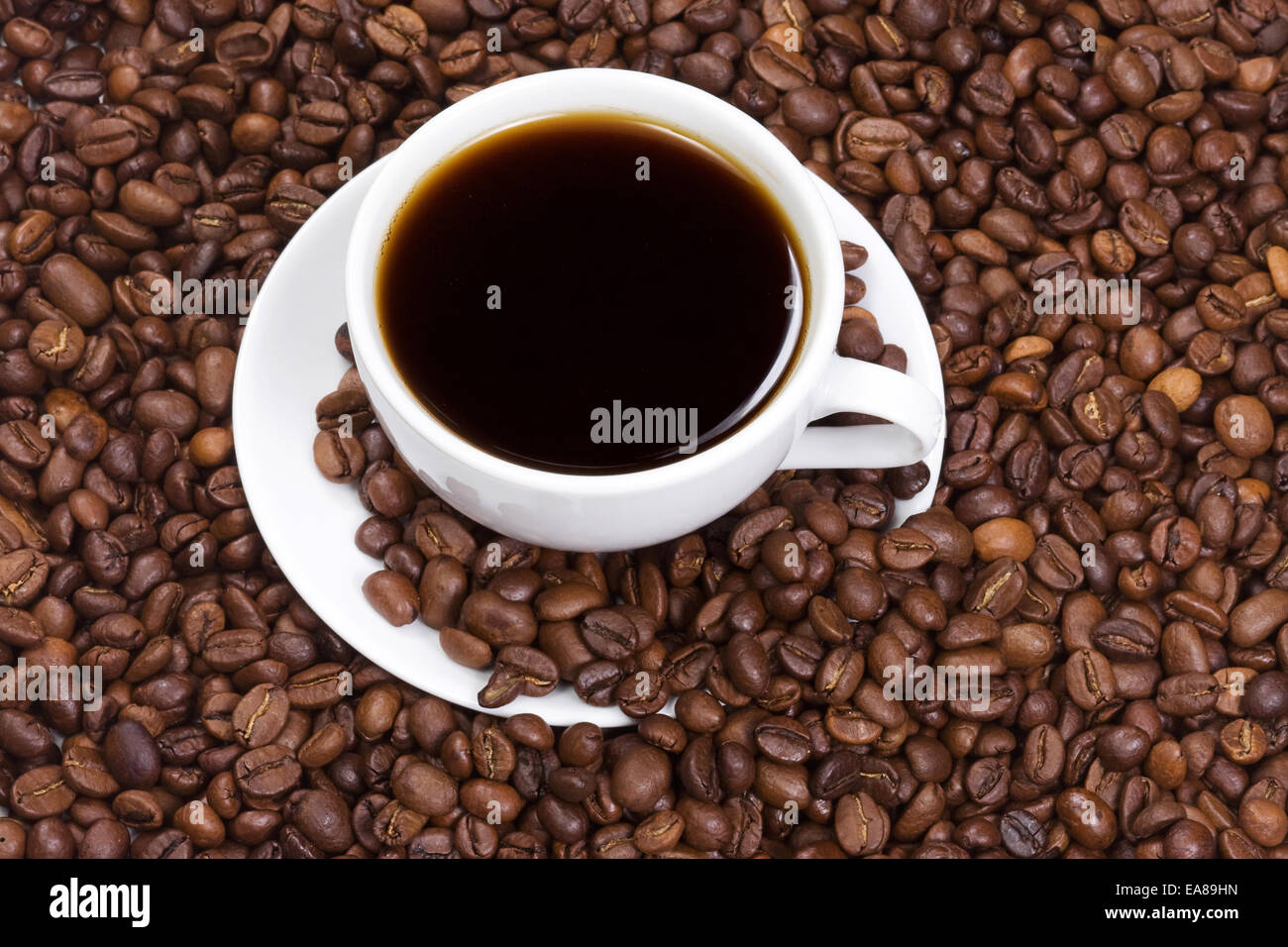 full cup of coffee and coffee beans Stock Photo Alamy