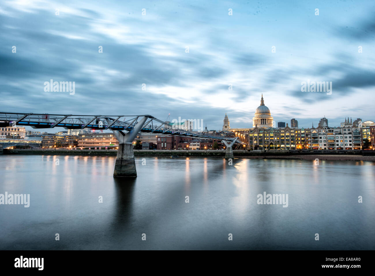 LONDON, UK - The Thames, with the Millenial Bridge and dome of St Paul's Cathedral, shortly after sunset. Stock Photo
