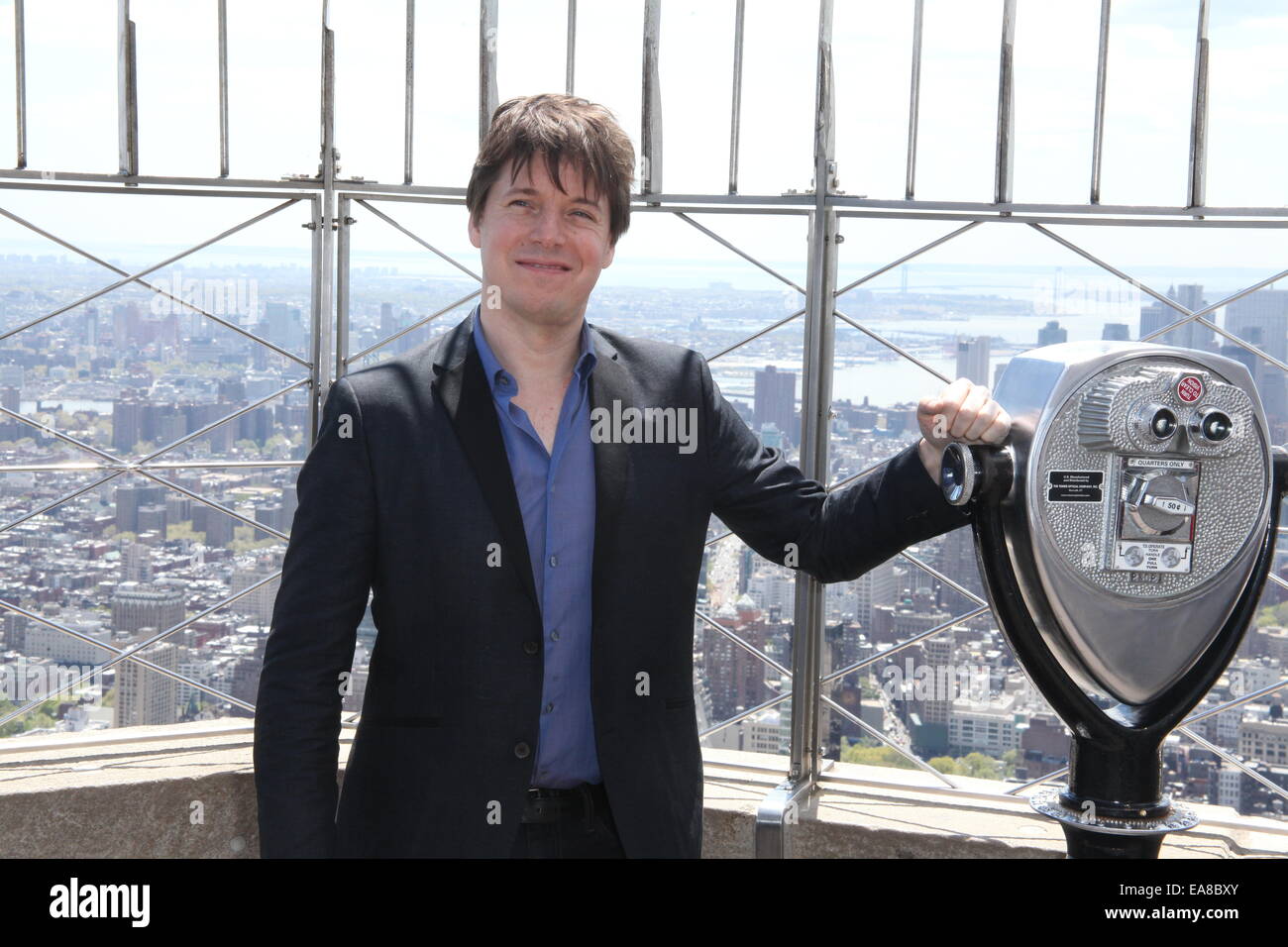 Violinst, Joshua Bell and Miss America 2014, Nina Davuluri, switch on the lights of The Empire State Building in purple in honor of Education Through Music  Featuring: Jushua Bell Where: New York City, New York, United States When: 06 May 2014 Stock Photo