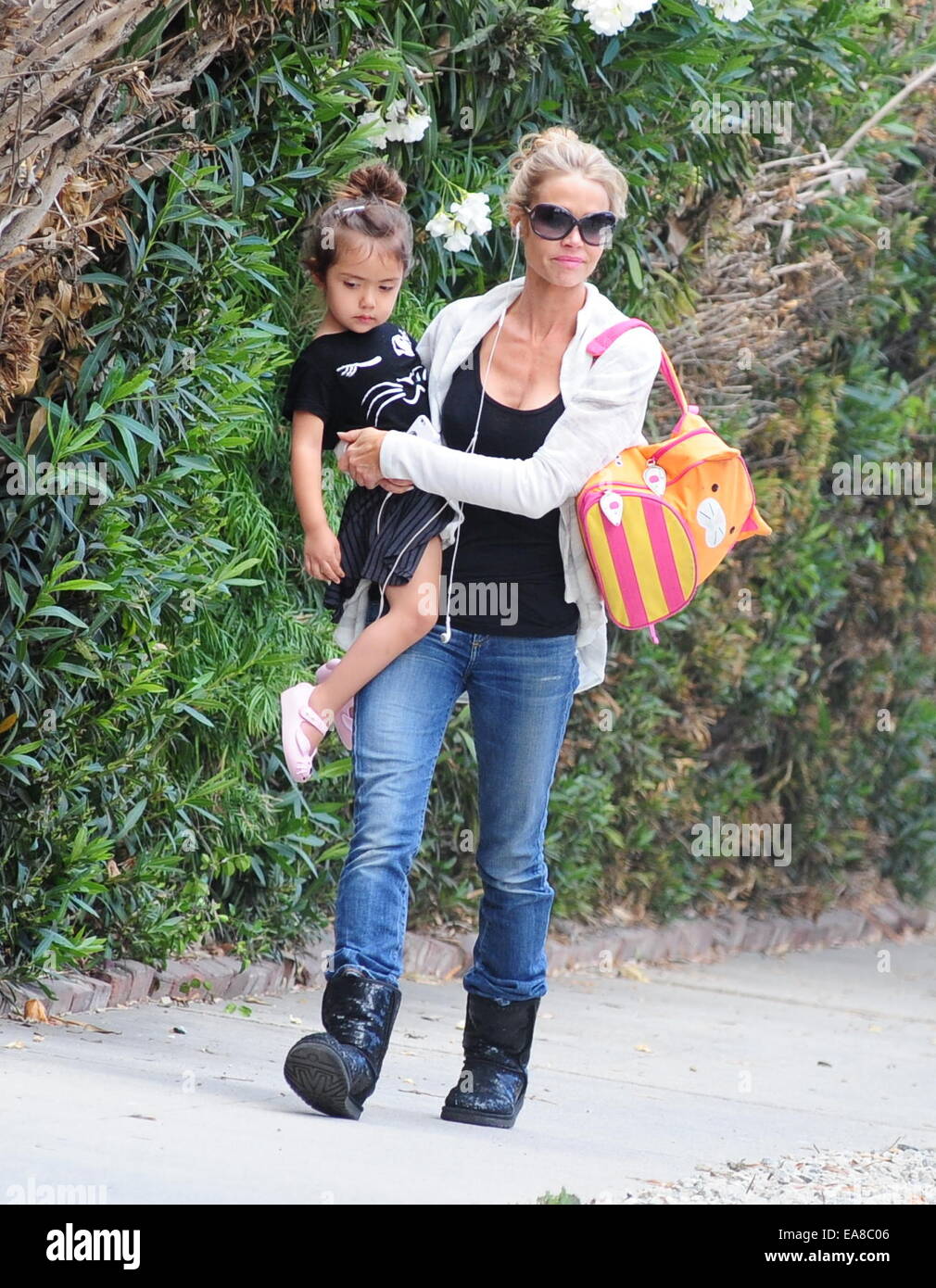 Denise Richards walking in Ugg boots and jeans carries her daughter Eloise  in her arms while out and about in West Hollywood Featuring: Denise  Richards,Eloise Sheen Where: Los Angeles, California, United States