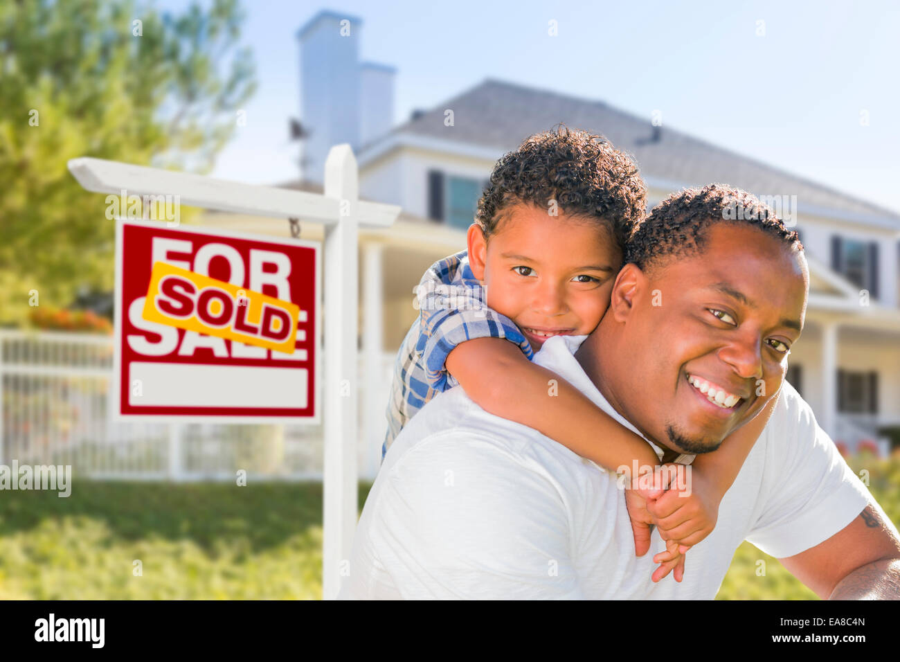 African American Father and Mixed Race Son In Front of Sold Home For ...