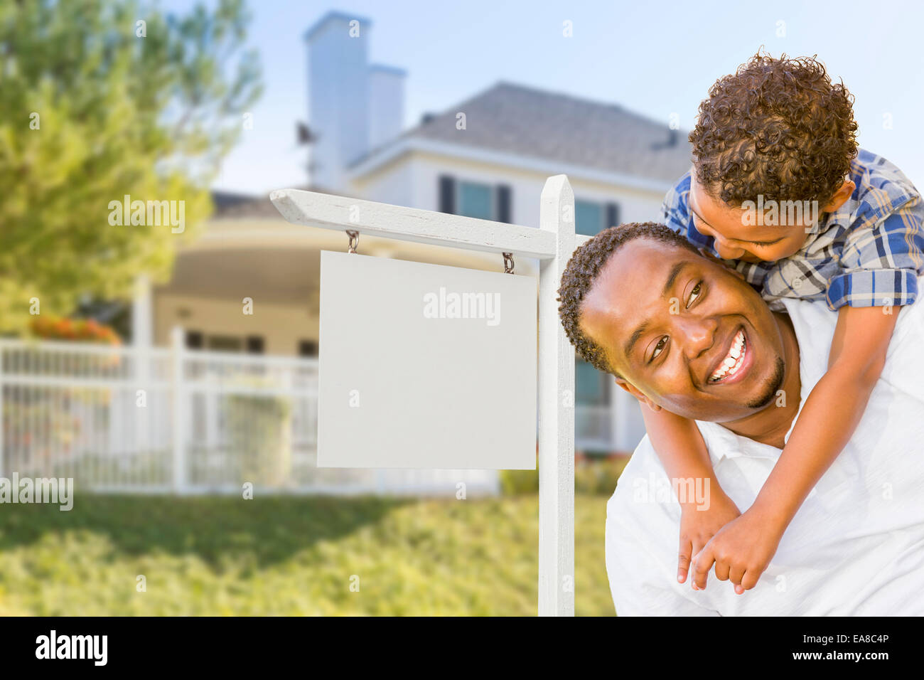 Happy African American Father and Mixed Race Son In Front of Blank Real ...