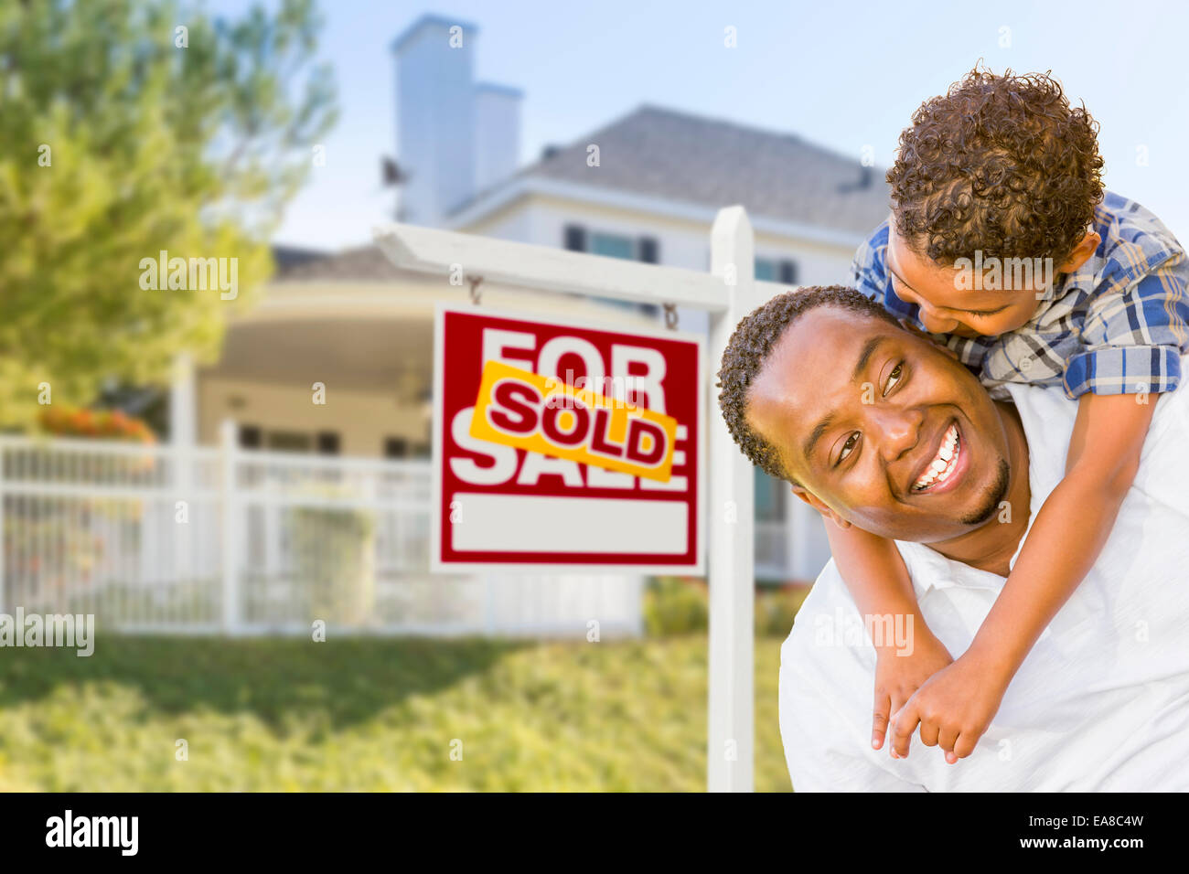 Happy African American Father and Mixed Race Son In Front of Sold Home ...