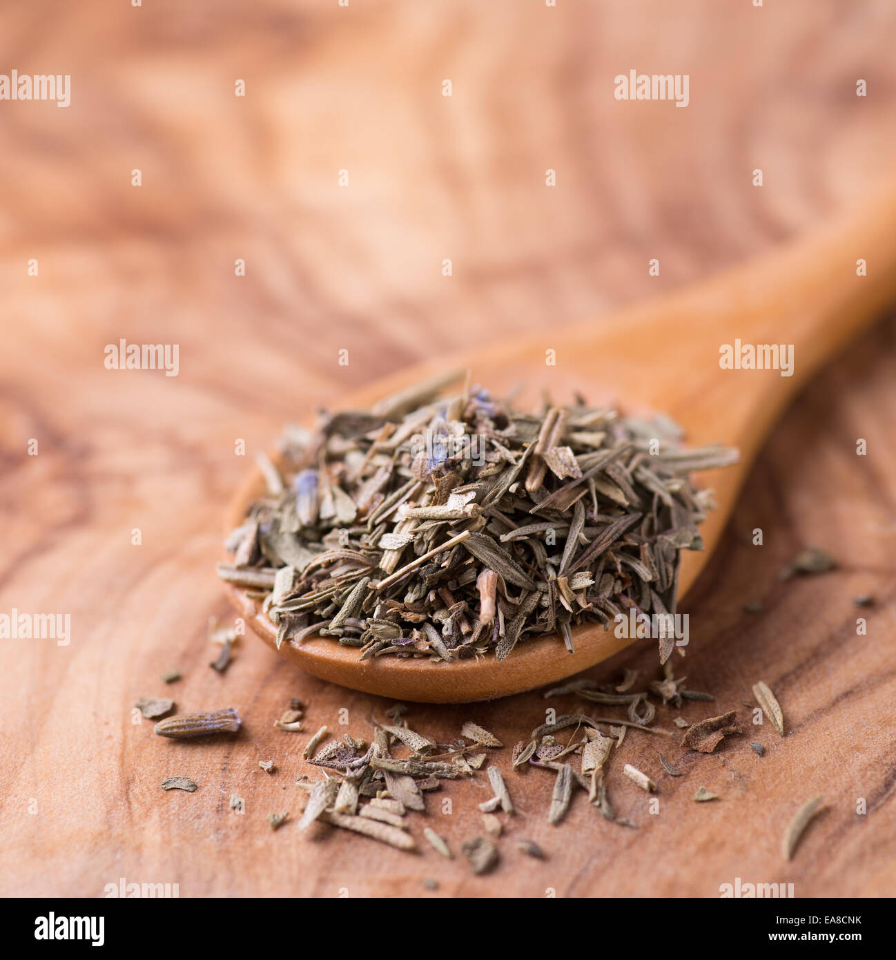 Herbs de Provence. Mixed dried herbs in spoon over wooden background, selective focus Stock