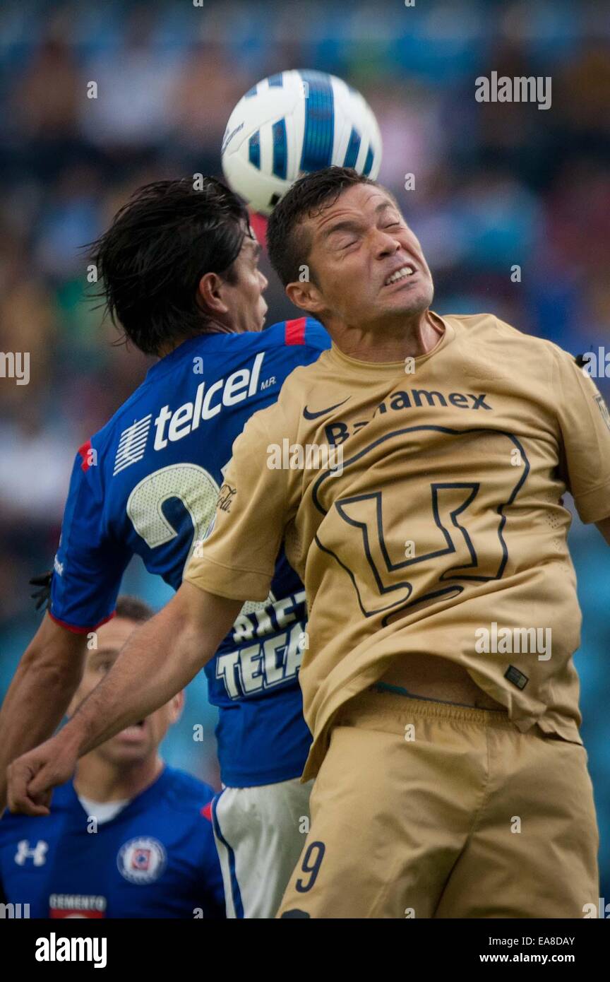 Mexico City, Mexico. 8th Nov, 2014. Javier Baez (L) of Cruz Azul vies for the ball with Dante Lopez of UNAM's Pumas during a match of the week 16 of the 2014 Opening Tournament of MX League in the Azul Stadium in Mexico City, capital of Mexico, on Nov. 8, 2014. Credit:  Pedro Mera/Xinhua/Alamy Live News Stock Photo