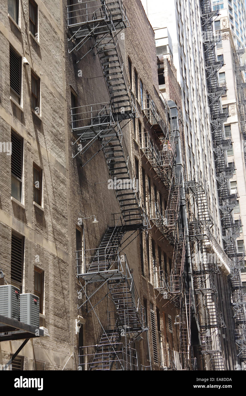 Cityscape - old fire escape stairs at the back of the old tall buildings Stock Photo