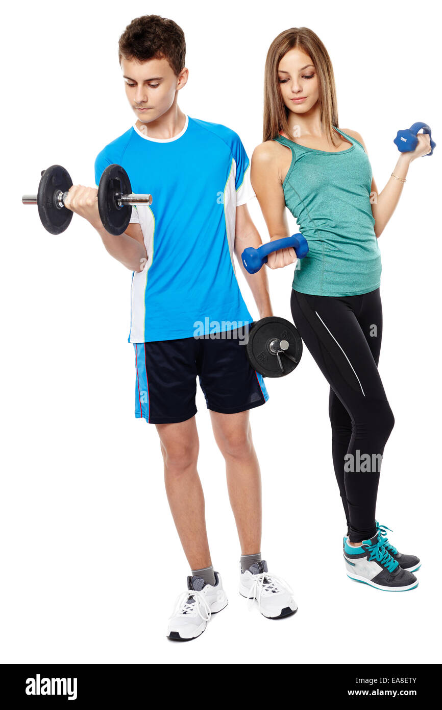 Two teenagers boy and girl doing fitness workout with weights isolated on white background Stock Photo