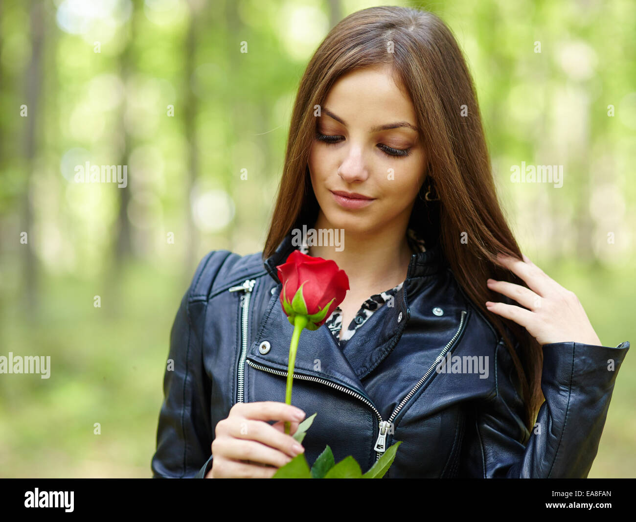 Beautiful teen girl with a red rose outdoor in the forest Stock Photo ...