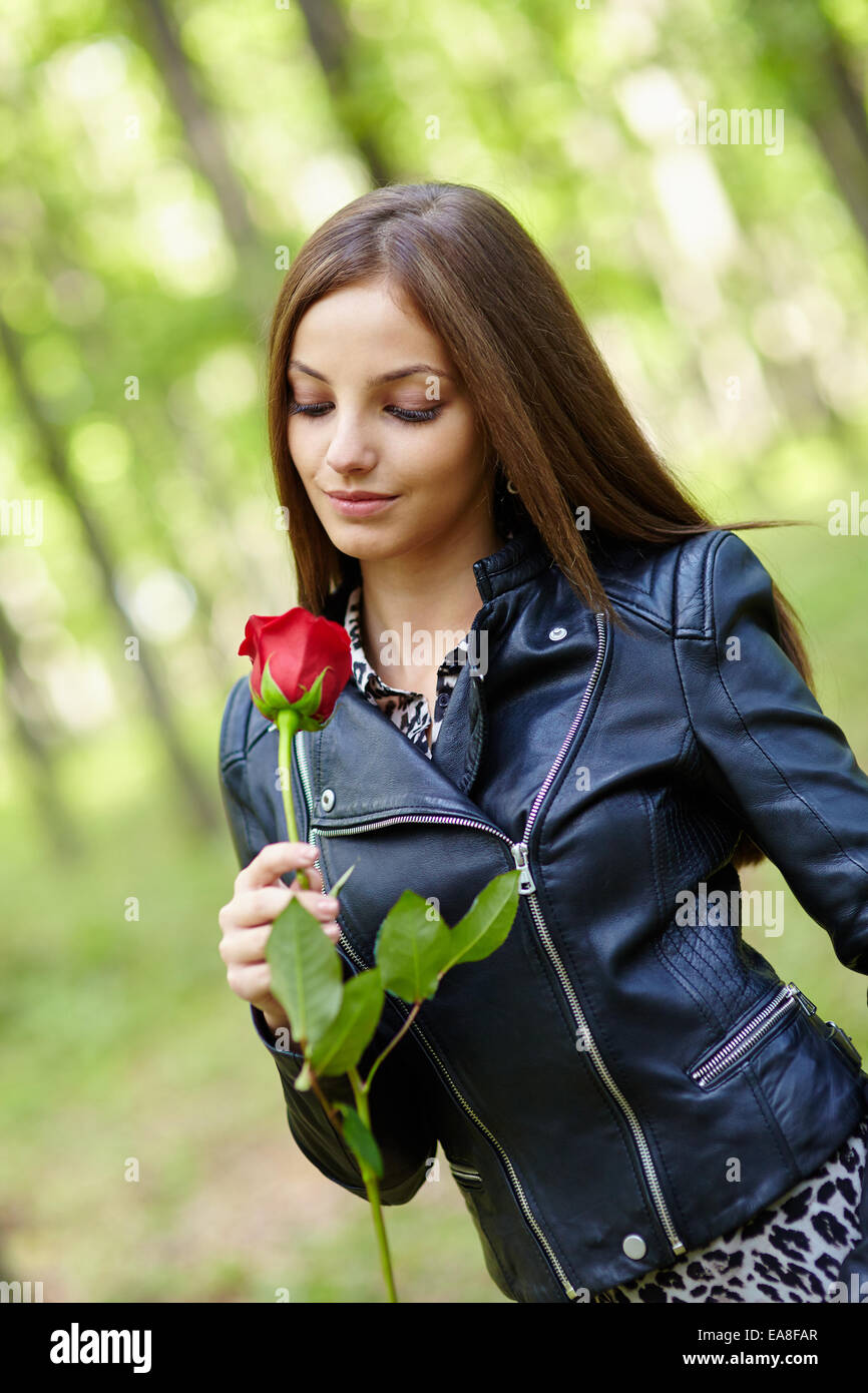 Beautiful teen girl with a red rose outdoor in the forest Stock Photo ...