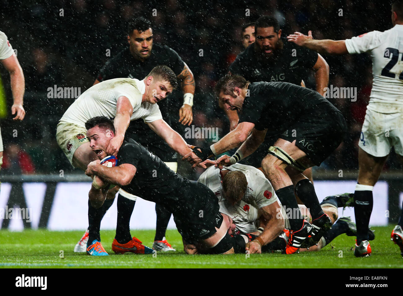 London, UK. 8th Nov, 2014. England's Owen Farrell stops New Zealand's Ryan Crotty just short of the line before New Zealand's Charlie Faumuina goes on to finish - QBE Autumn Internationals - England vs New Zealand. Credit:  Cal Sport Media/Alamy Live News Stock Photo