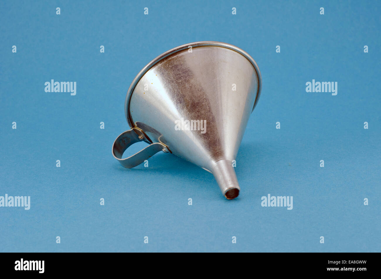one retro metal funnel hopper tool on blue background Stock Photo Alamy