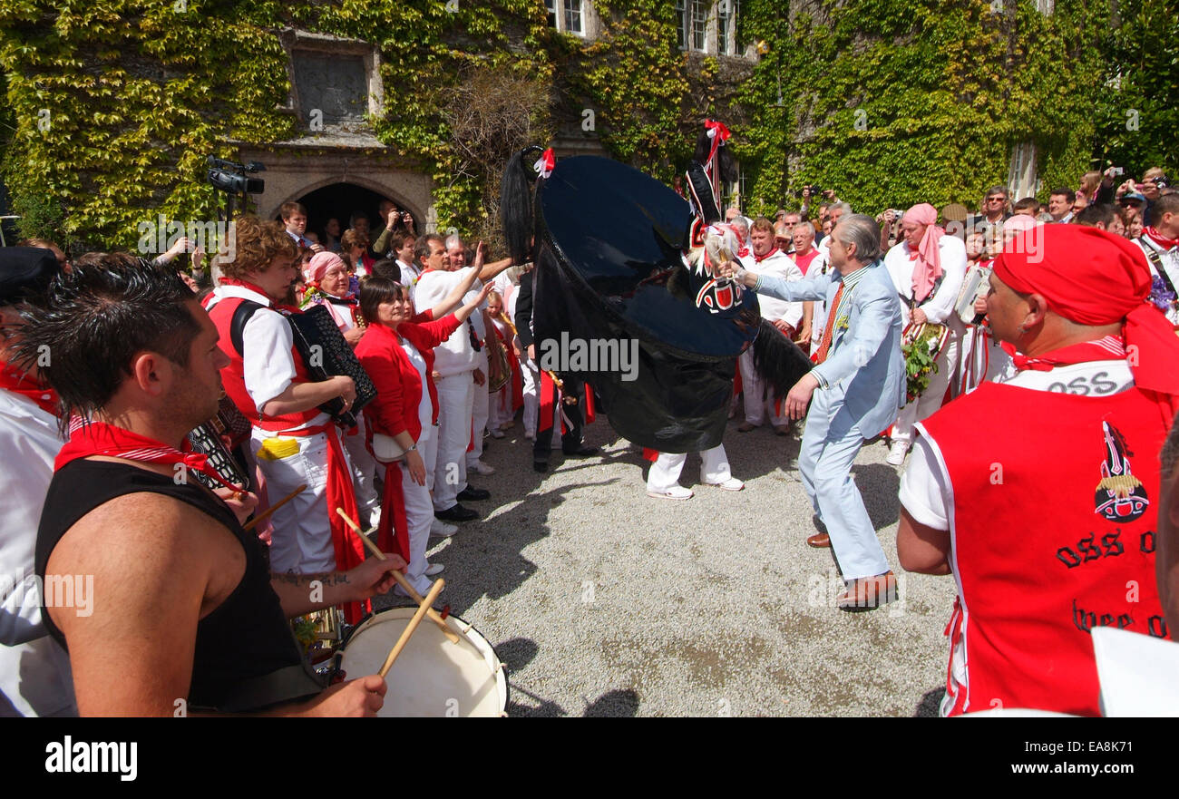 Close up of band red Oss & Peter Prideaux-Brune dancing outside Prideaux House Prideaux Place in Padstow on the first of may Obb Stock Photo