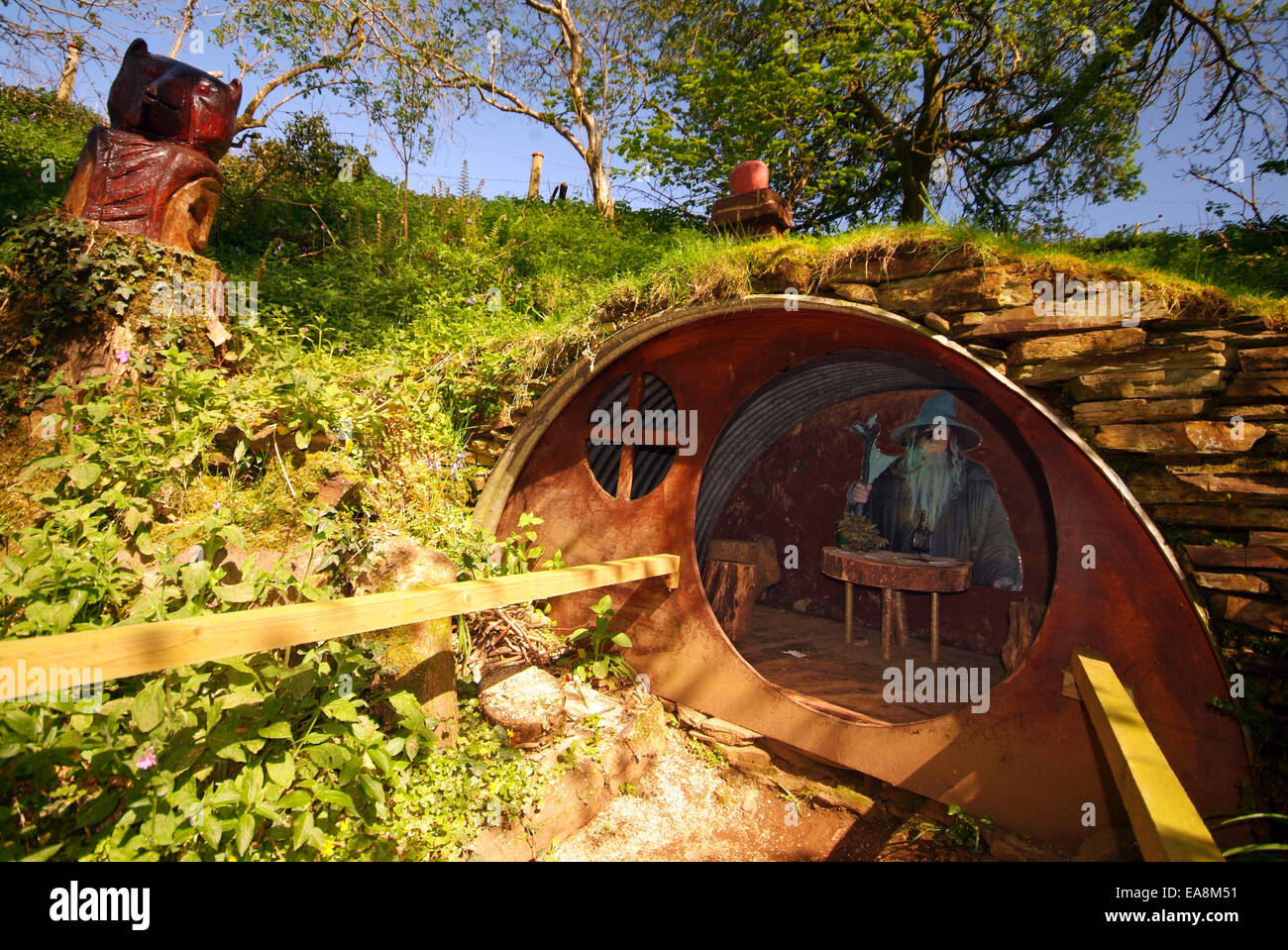 The Hobbit house Exhibit with the wizard Gandalf inside at the Carnglaze Caverns tourist attraction on wooded hillside of the Lo Stock Photo