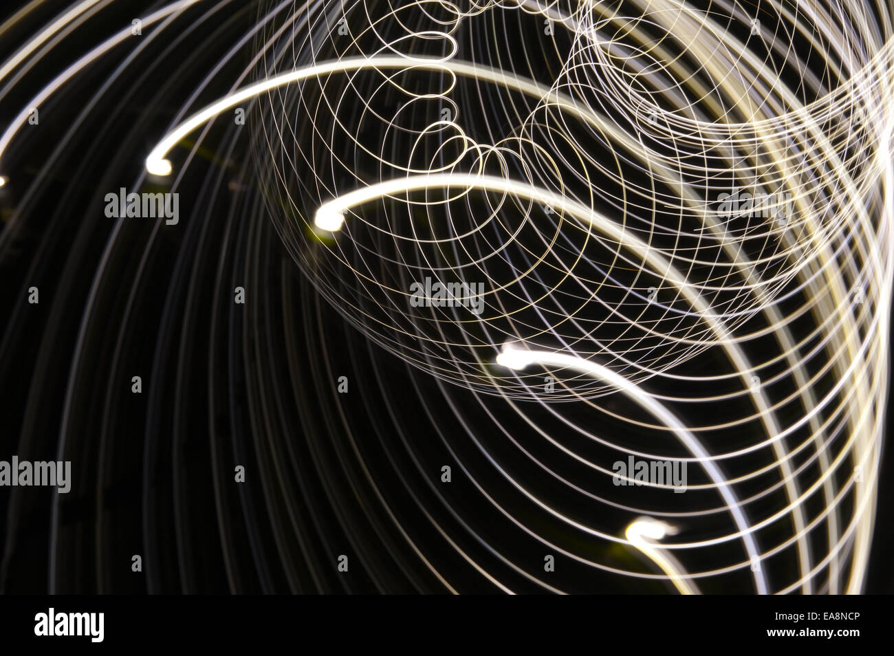 swirling spinning motion and trails traces of moving lights creating patterns vortice Stock Photo