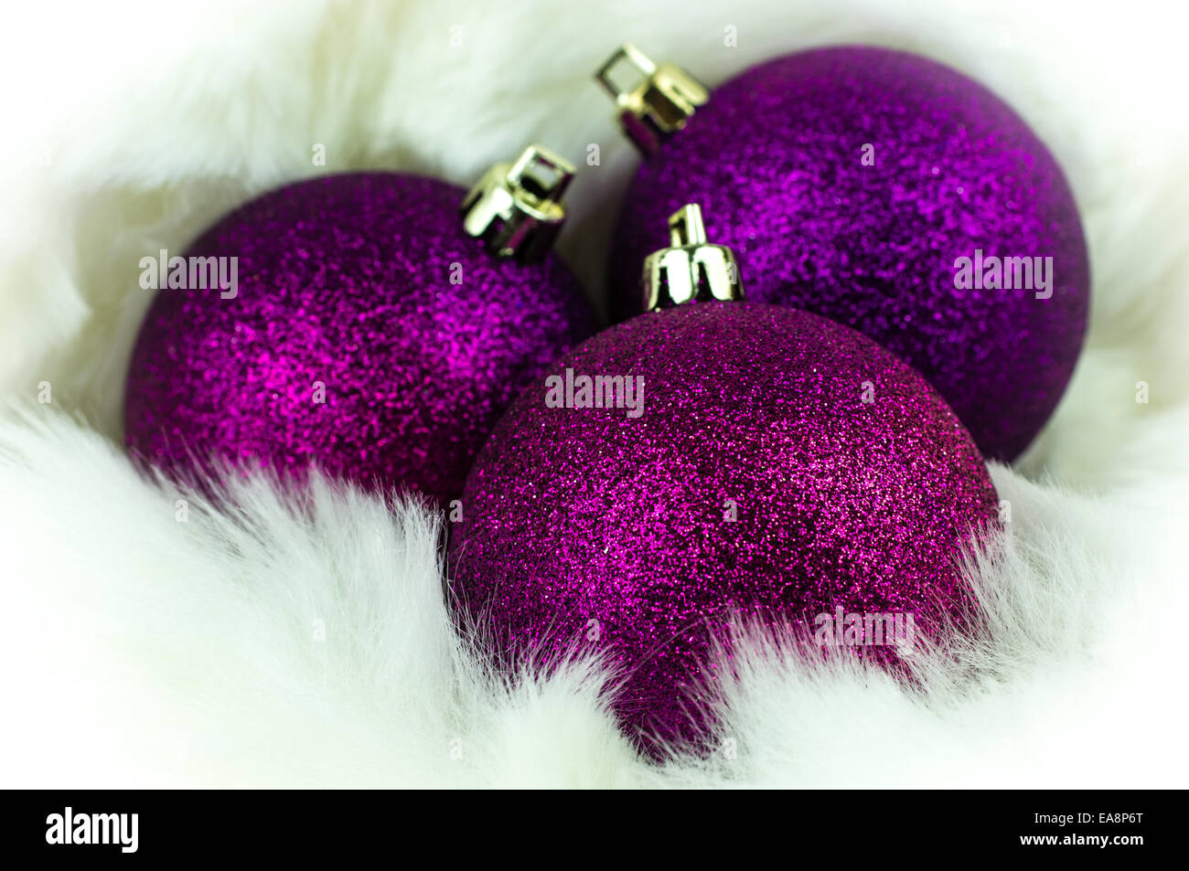 Purple christmas decorations on white fur Stock Photo