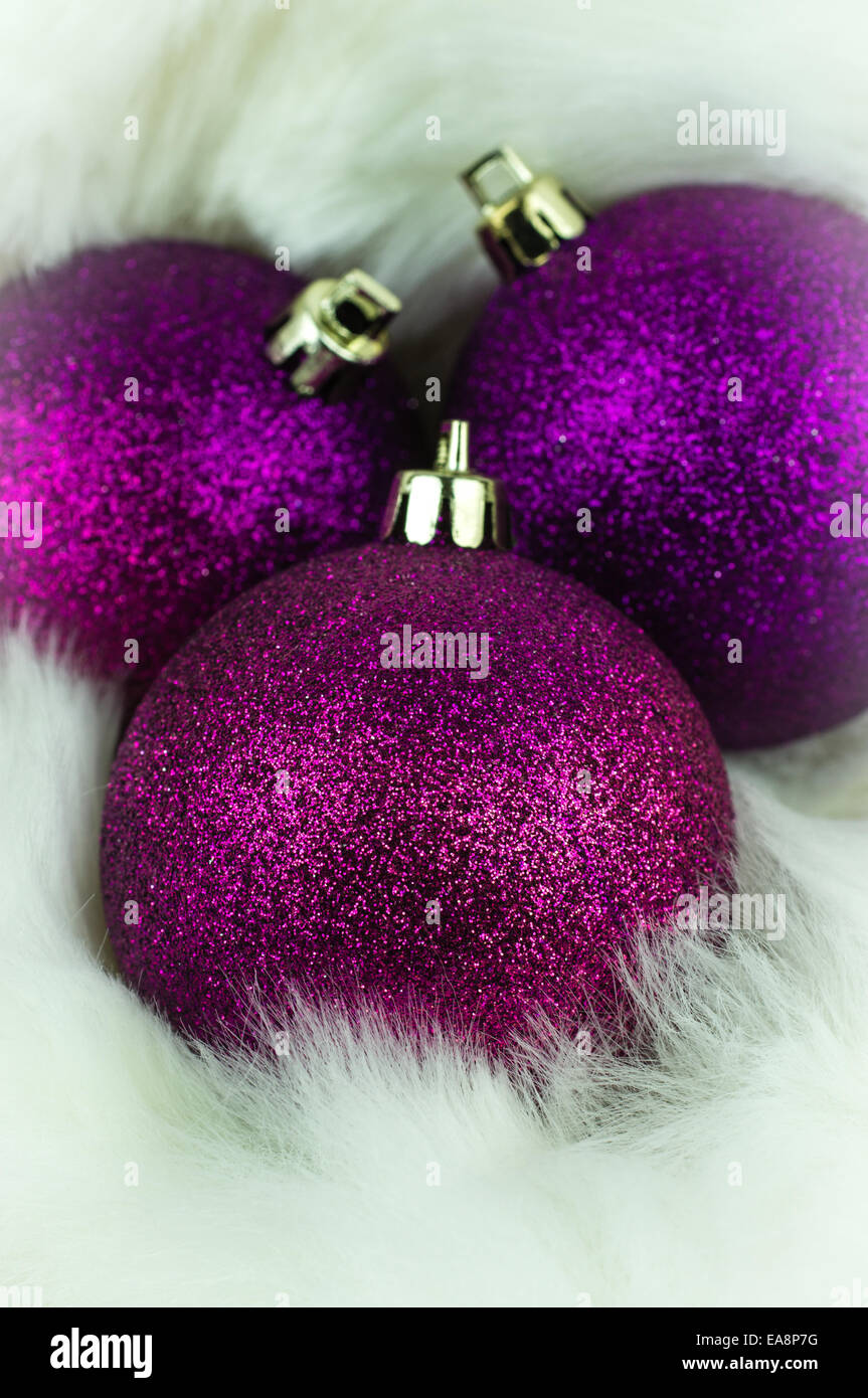 Purple christmas decorations on white fur Stock Photo
