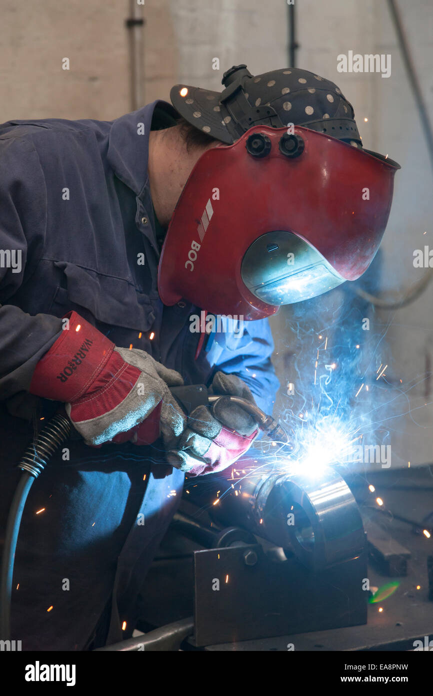 Engineer welding a metal part Stock Photo Alamy