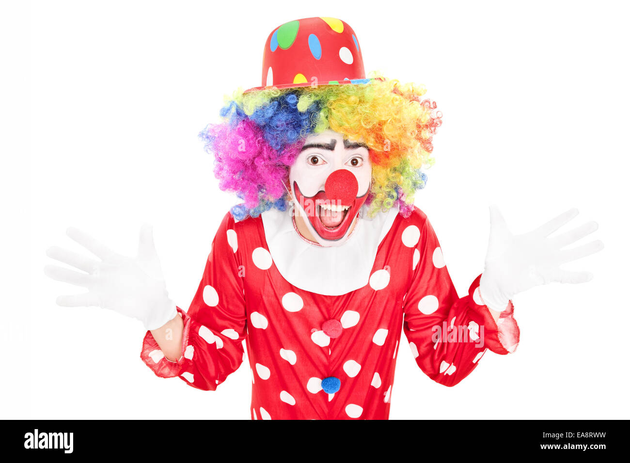 Happy male clown gesturing with hands isolated against white background Stock Photo