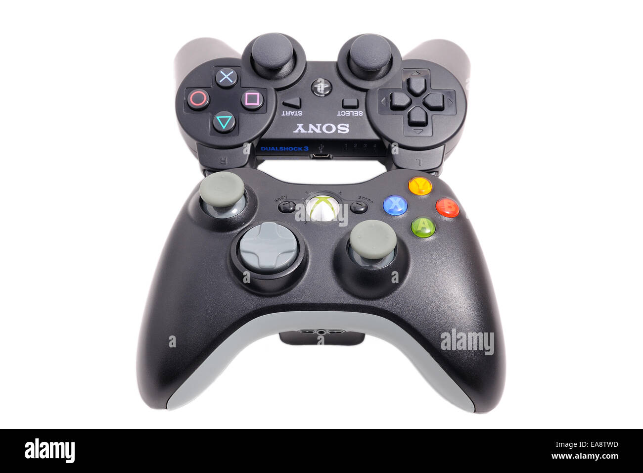 BARCELONA, SPAIN - APR 18, 2014: The DualShock 3 wireless controller, in front of its big rival of Microsoft Xbox 360. Stock Photo